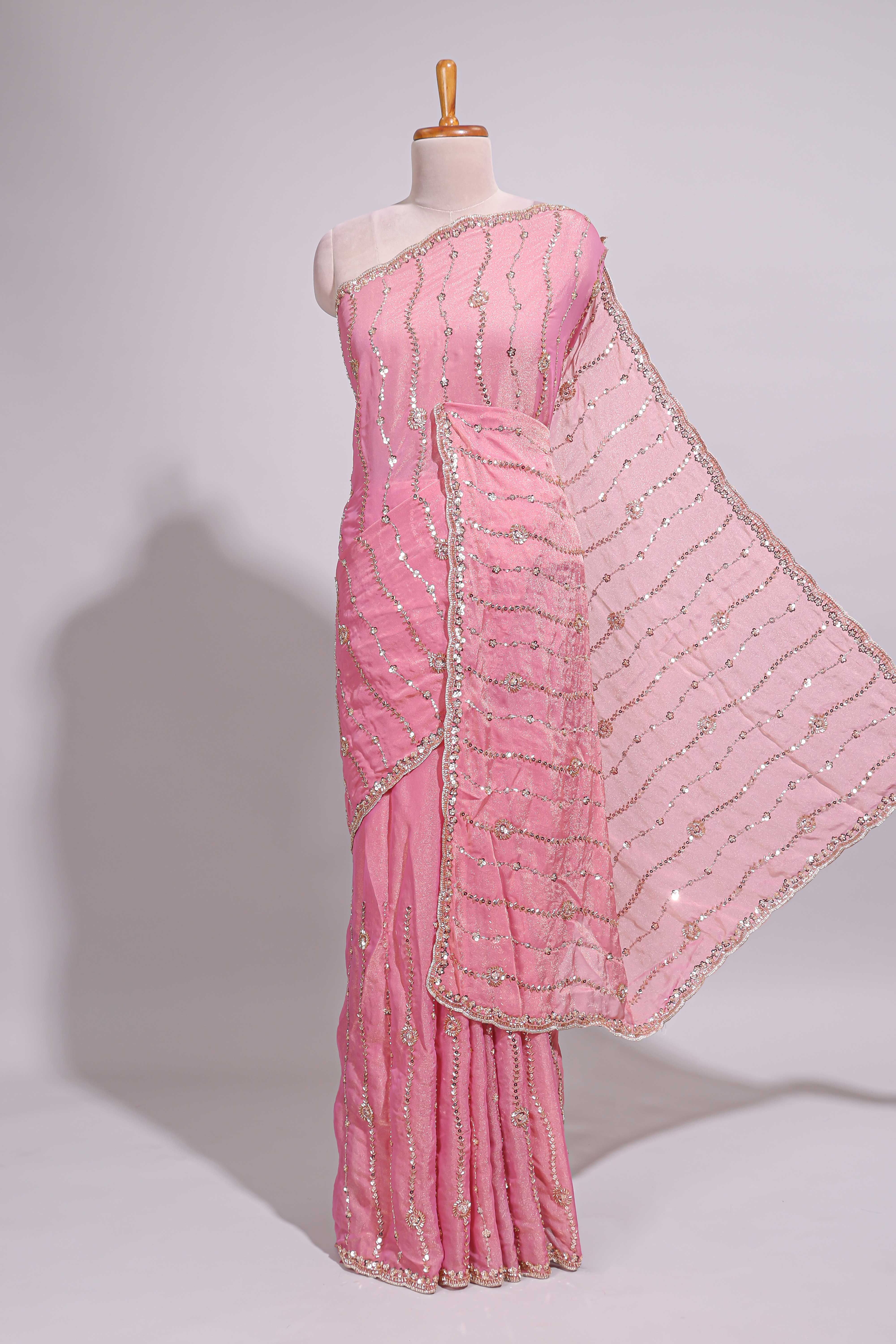 Baby pink saree with silver sequin wavy line embroidery floral motifs and a sparkling embellished border along with matching blouse