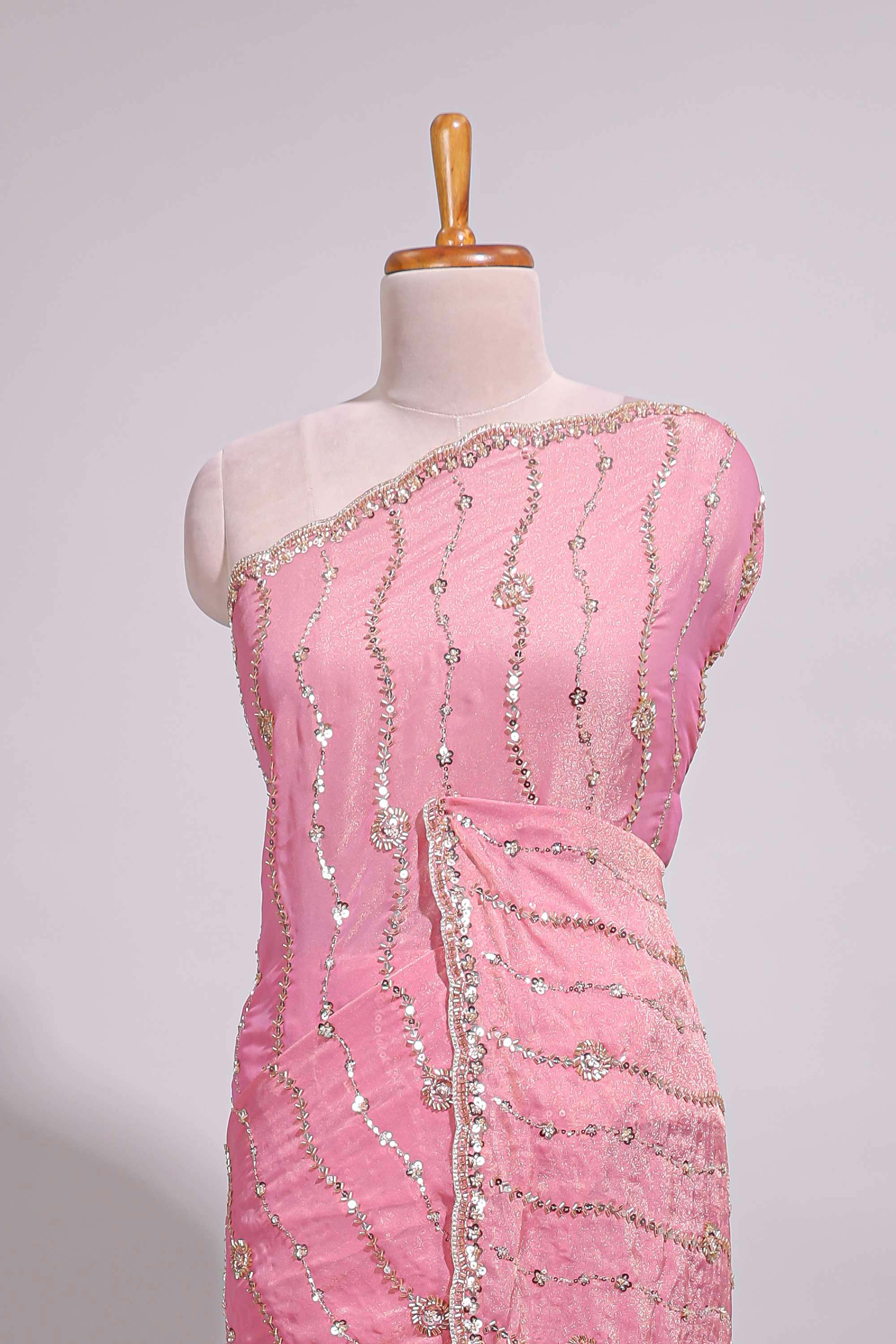 Baby pink saree with silver sequin wavy line embroidery floral motifs and a sparkling embellished border along with matching blouse
