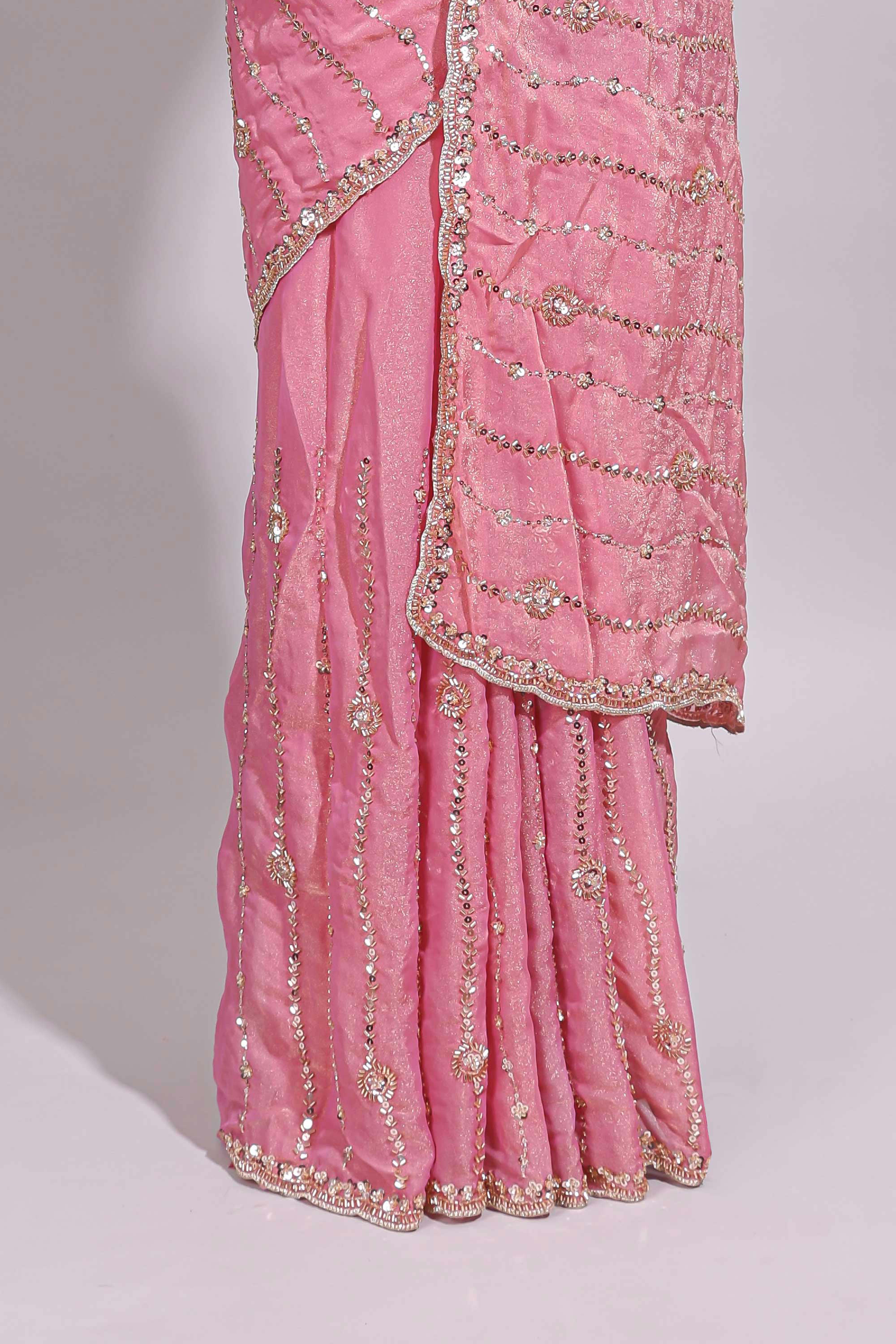 Baby pink saree with silver sequin wavy line embroidery floral motifs and a sparkling embellished border along with matching blouse