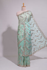Mint green saree with silver sequin abstract wave embroidery and a detailed embellished border along with work blouse