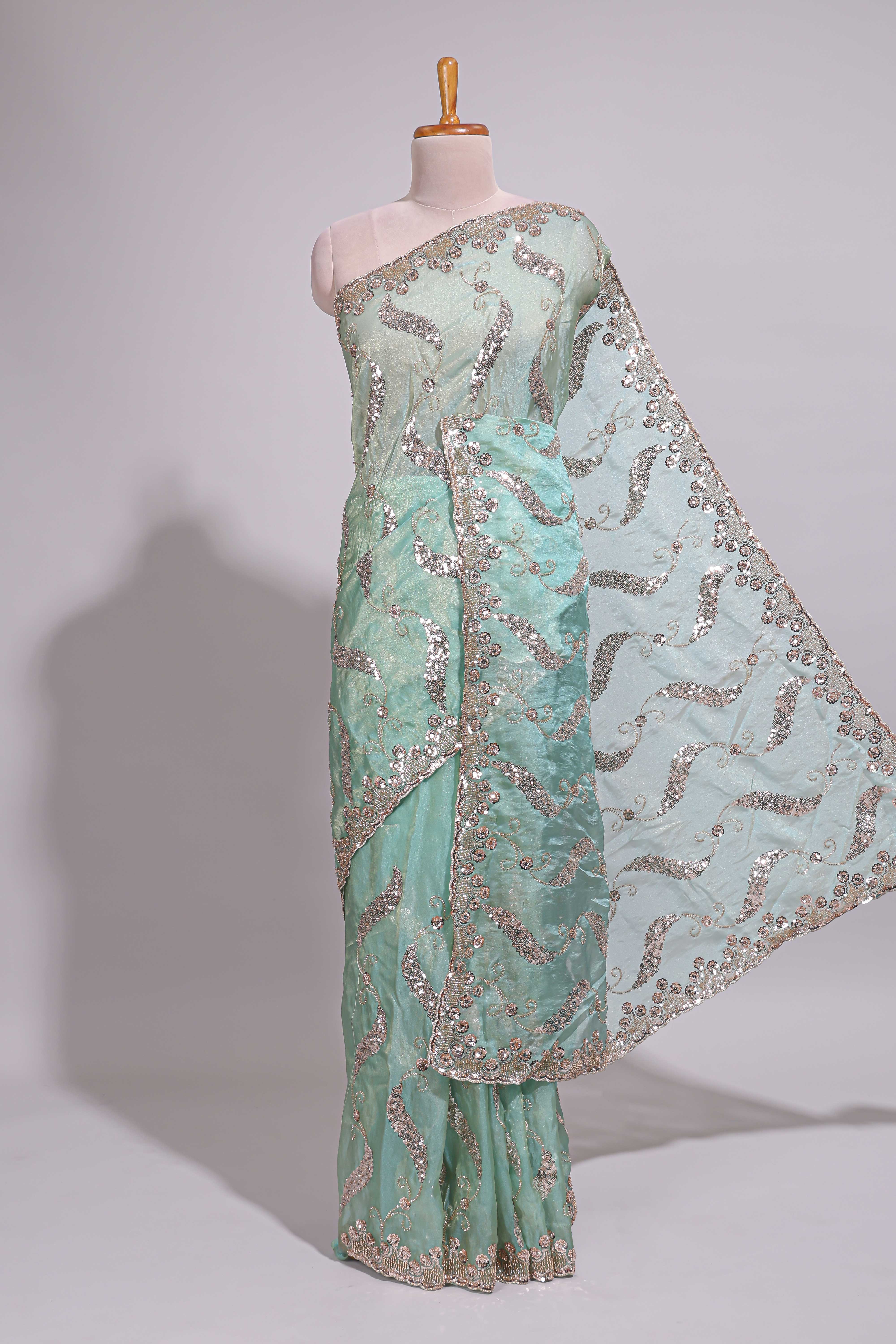 Mint green saree with silver sequin abstract wave embroidery and a detailed embellished border along with work blouse