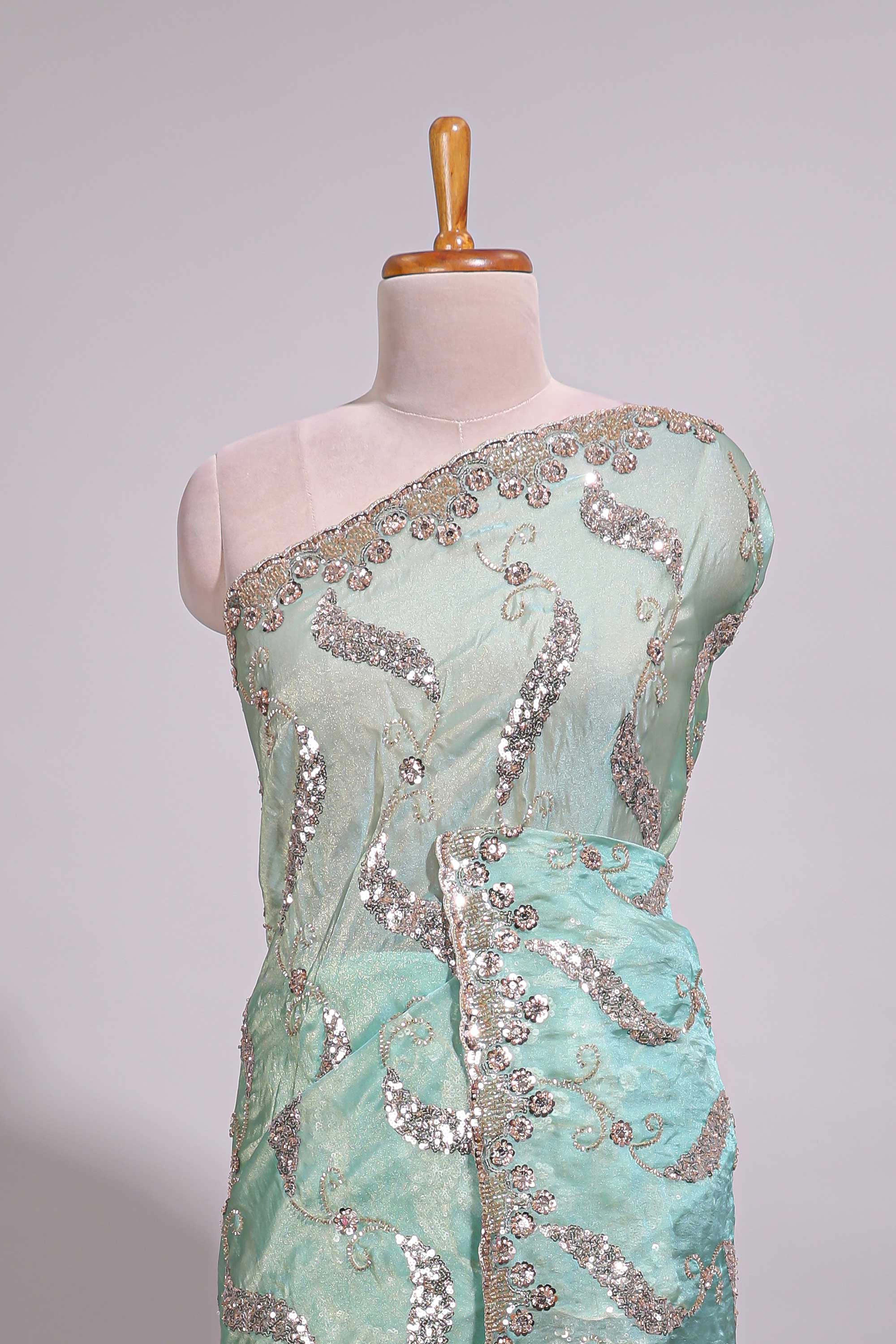 Mint green saree with silver sequin abstract wave embroidery and a detailed embellished border along with work blouse