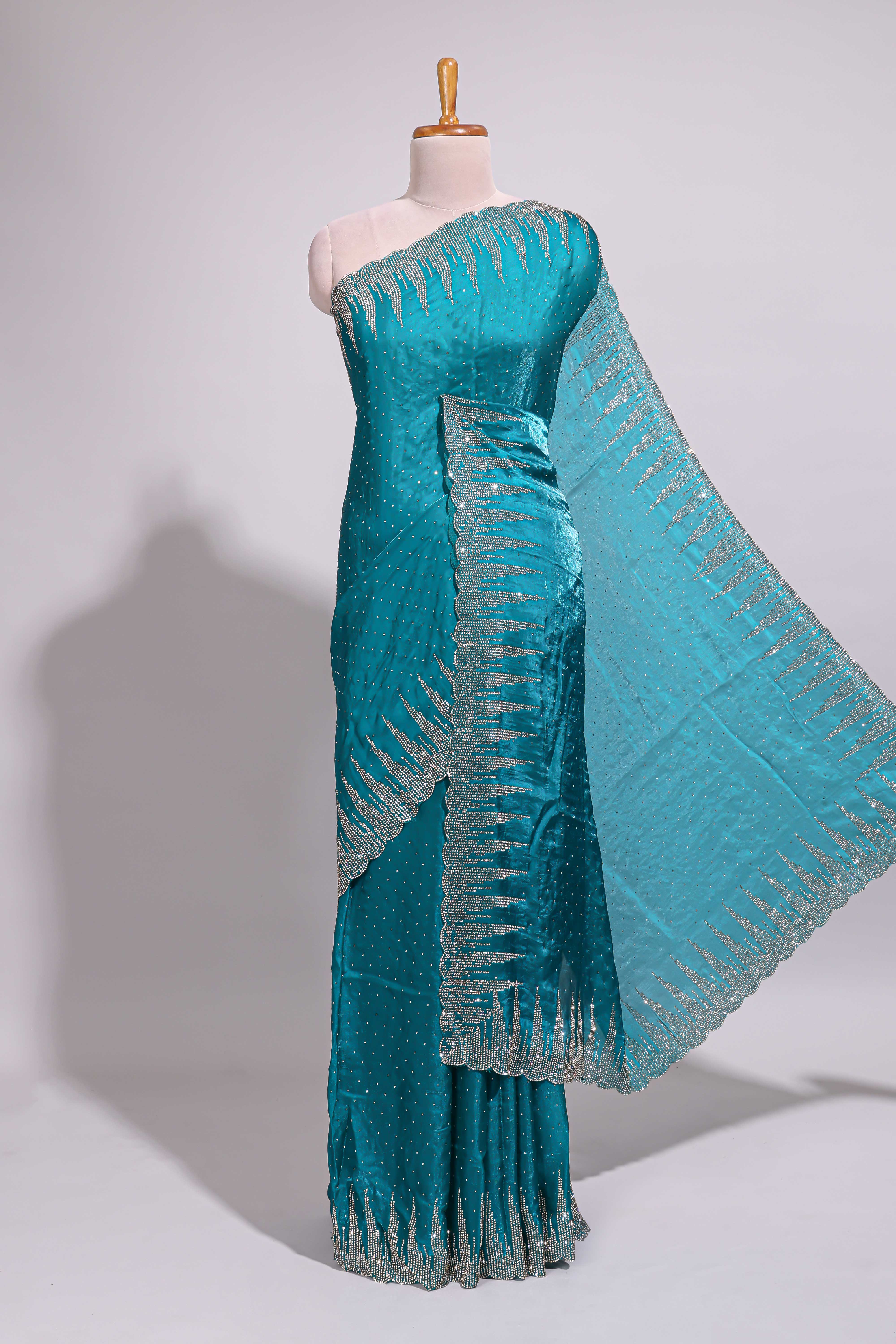Teal blue saree with sequin striped embroidery scattered butti detailing and embellished border along with matching blouse