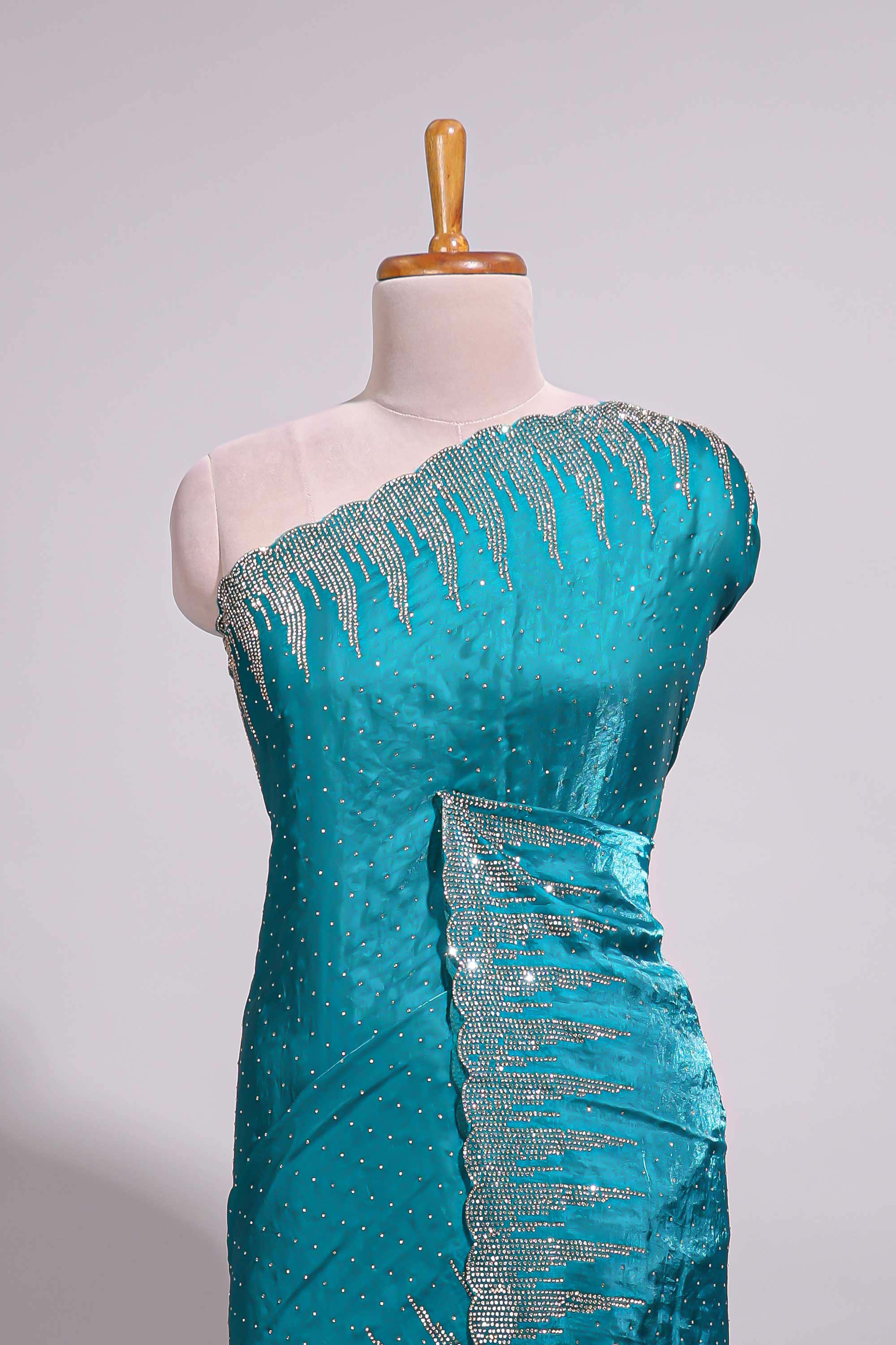 Teal blue saree with sequin striped embroidery scattered butti detailing and embellished border along with matching blouse