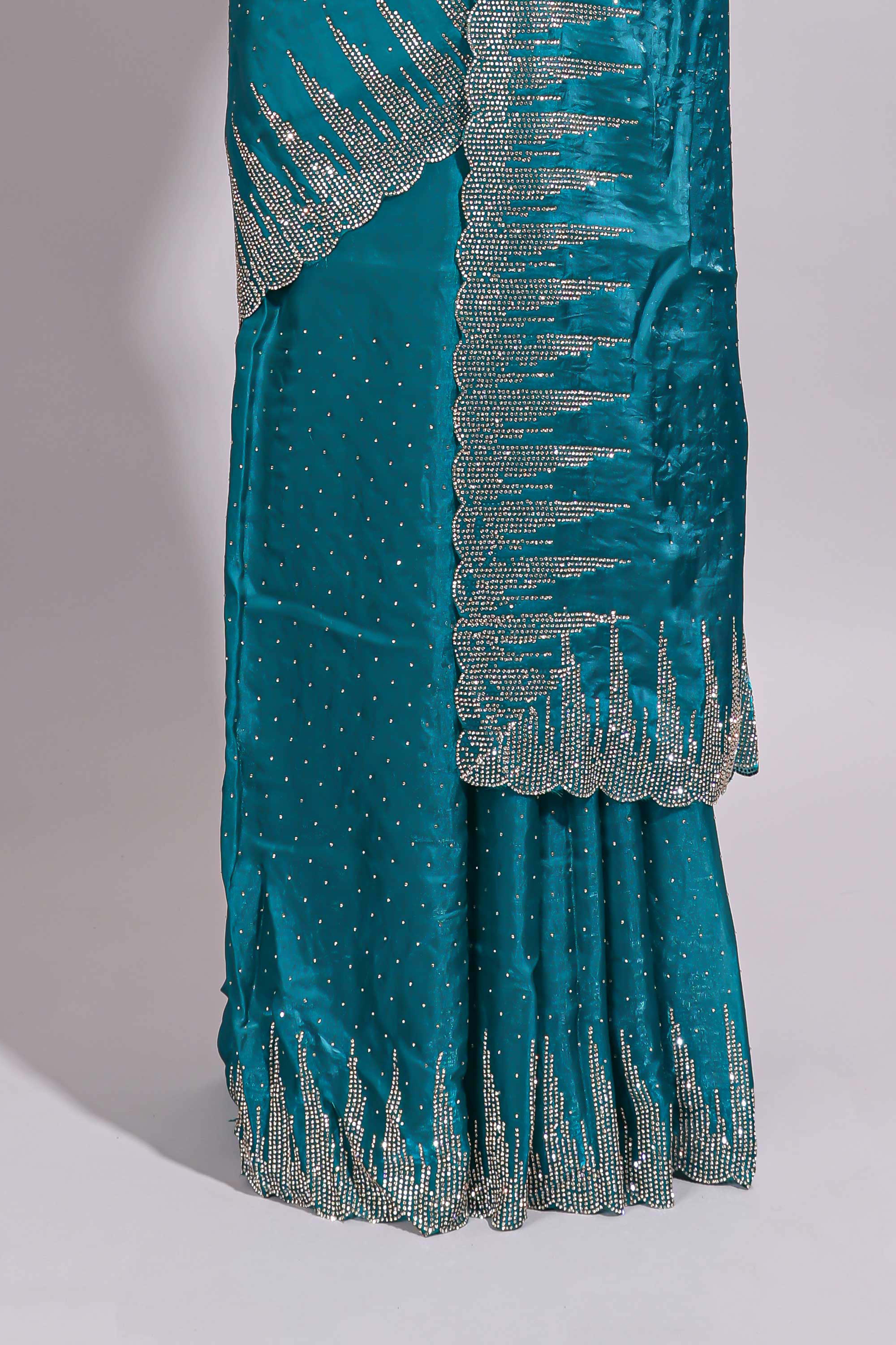 Teal blue saree with sequin striped embroidery scattered butti detailing and embellished border along with matching blouse