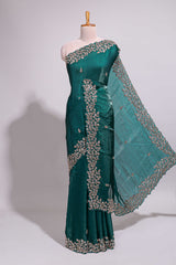 Bottle green saree with elegant golden floral embroidery and a rich embellished border along with matching blouse