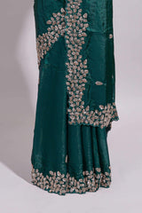 Bottle green saree with elegant golden floral embroidery and a rich embellished border along with matching blouse