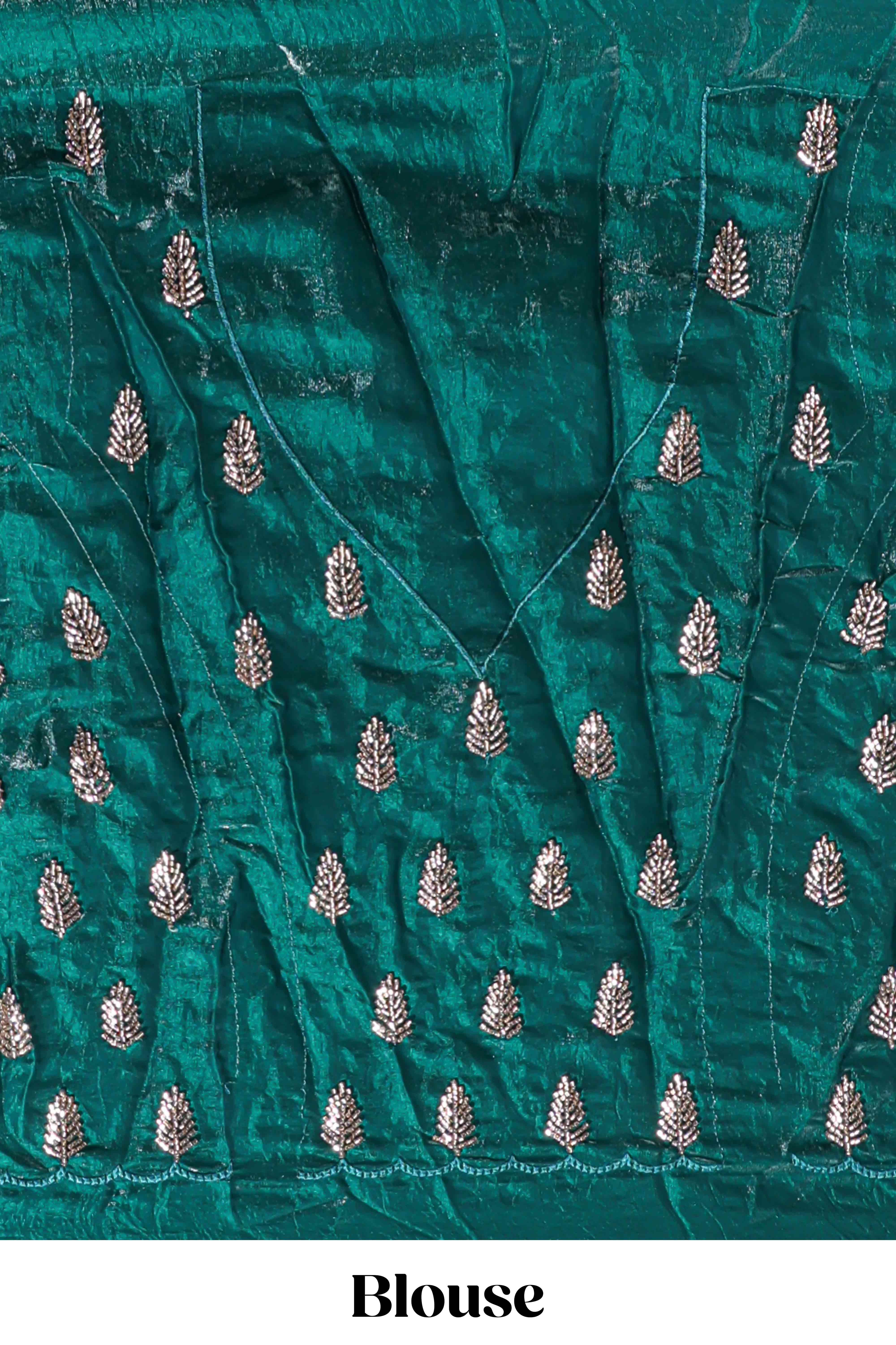 Bottle green saree with elegant golden floral embroidery and a rich embellished border along with matching blouse