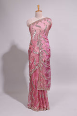 Dusty pink saree with sequin abstract wave embroidery and a detailed embellished border along with matching blouse