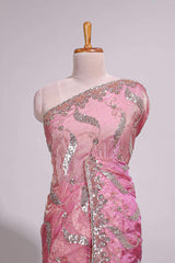 Dusty pink saree with sequin abstract wave embroidery and a detailed embellished border along with matching blouse