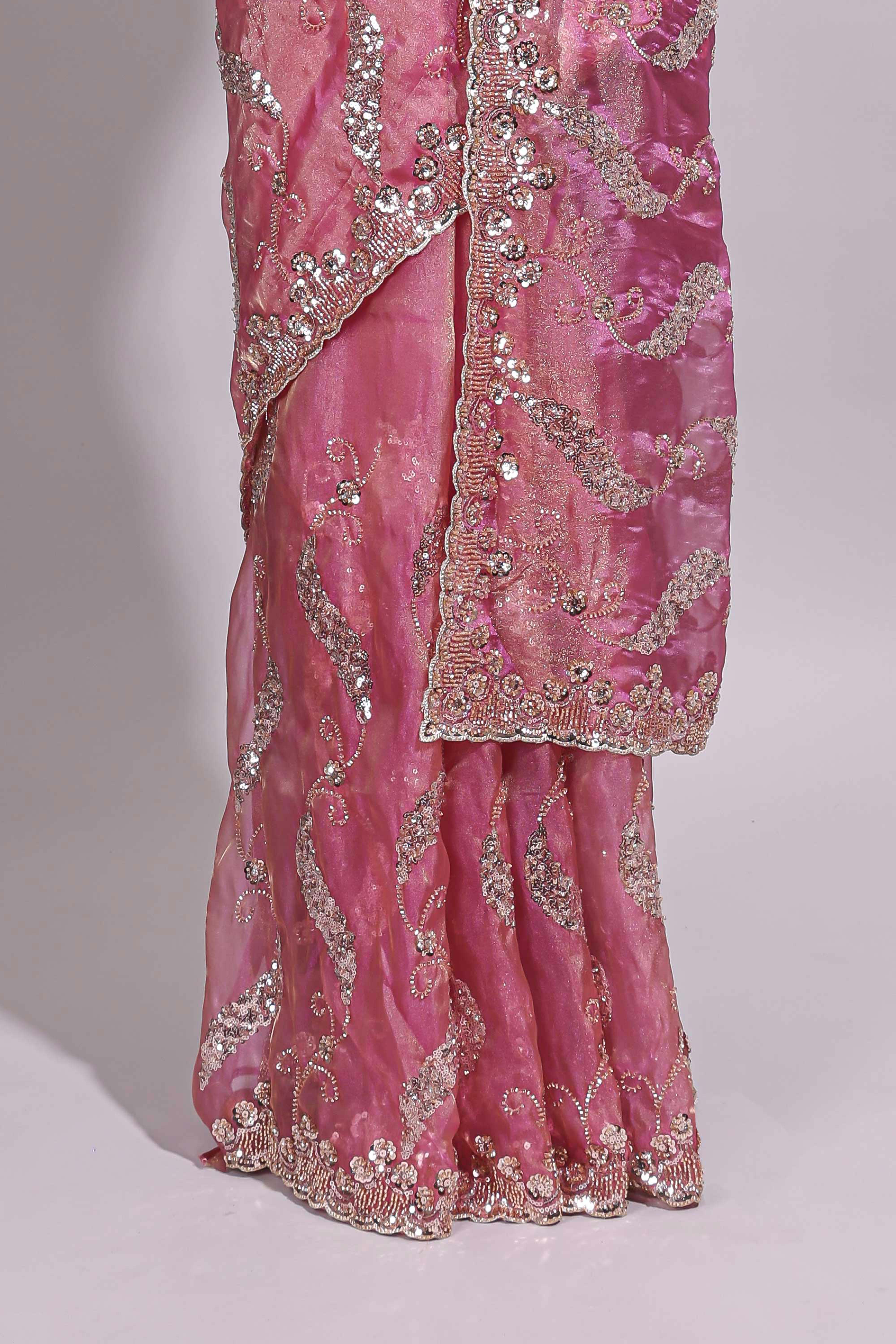 Dusty pink saree with sequin abstract wave embroidery and a detailed embellished border along with matching blouse