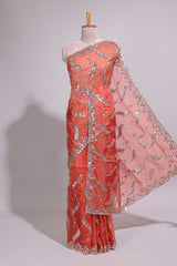 Dusty orange saree with sequin abstract wave embroidery and a detailed embellished border along with matching blouse