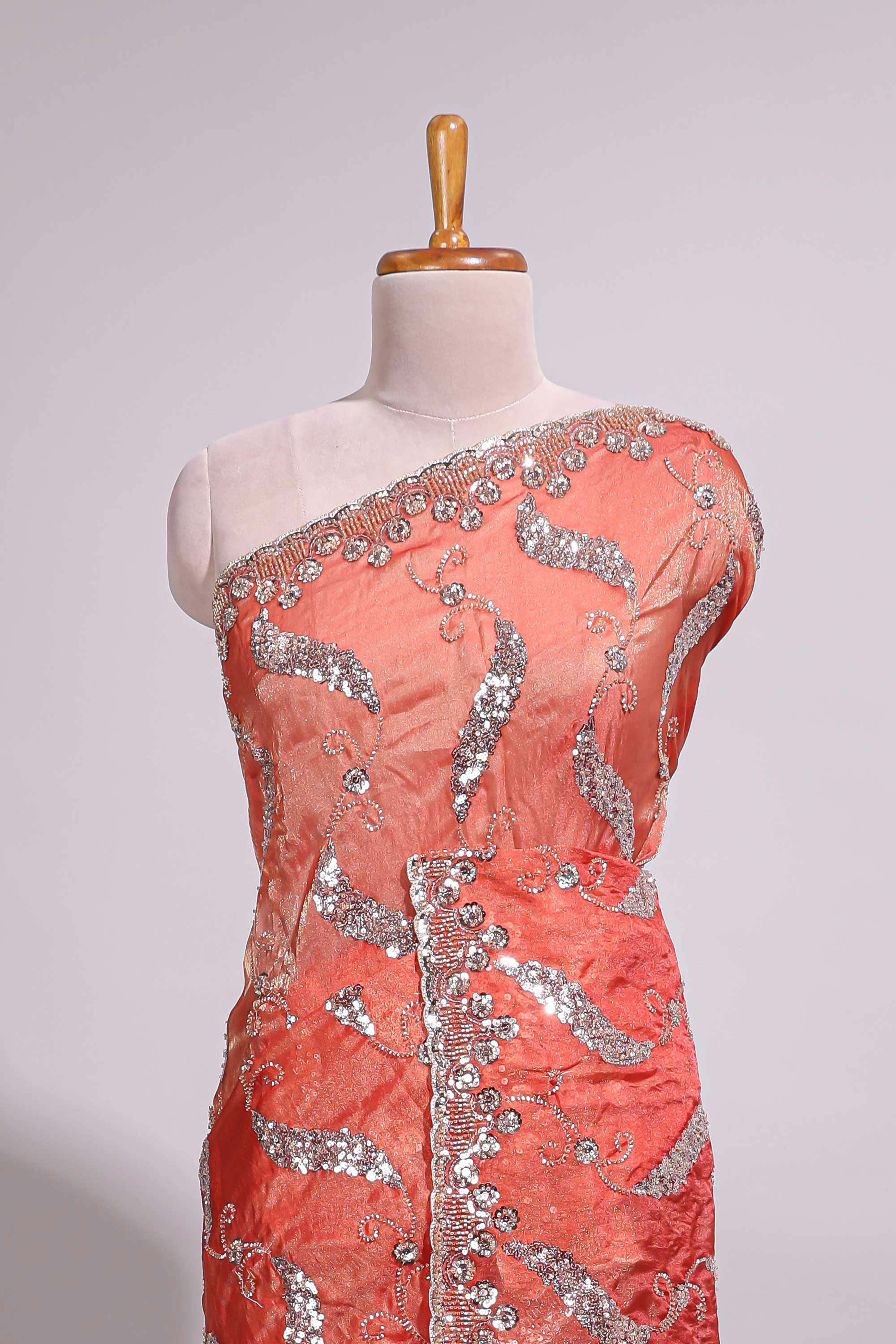 Dusty orange saree with sequin abstract wave embroidery and a detailed embellished border along with matching blouse