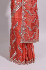 Dusty orange saree with sequin abstract wave embroidery and a detailed embellished border along with matching blouse