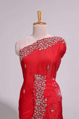 Bright red saree with elegant golden floral embroidery and a rich embellished border along with matching blouse
