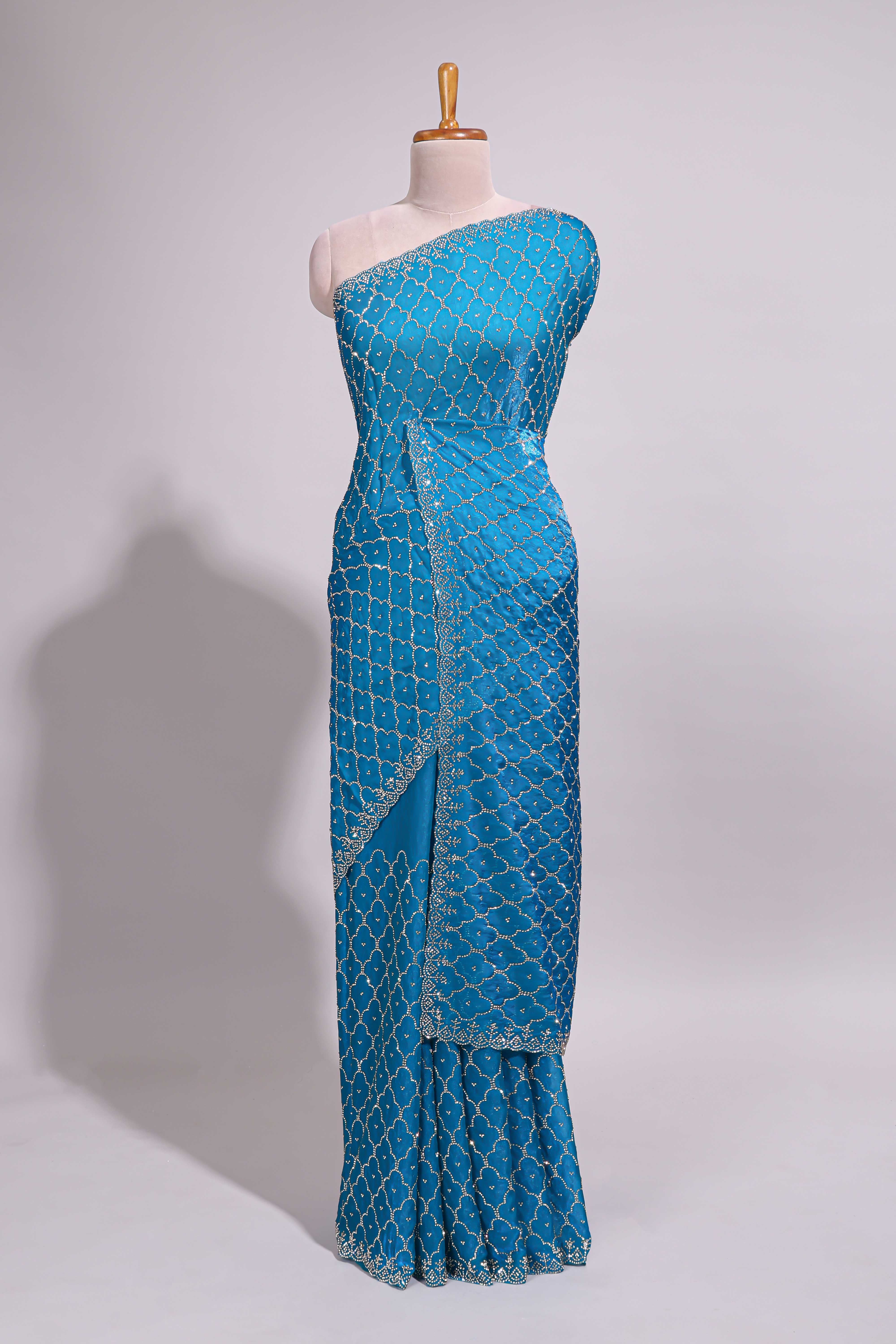 Blue saree with all over scallop pattern embroidery sequin detailing and a delicate embellished border along with matching blouse