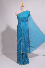 Blue saree with all over scallop pattern embroidery sequin detailing and a delicate embellished border along with matching blouse
