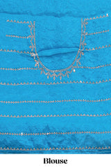 Blue saree with all over scallop pattern embroidery sequin detailing and a delicate embellished border along with matching blouse