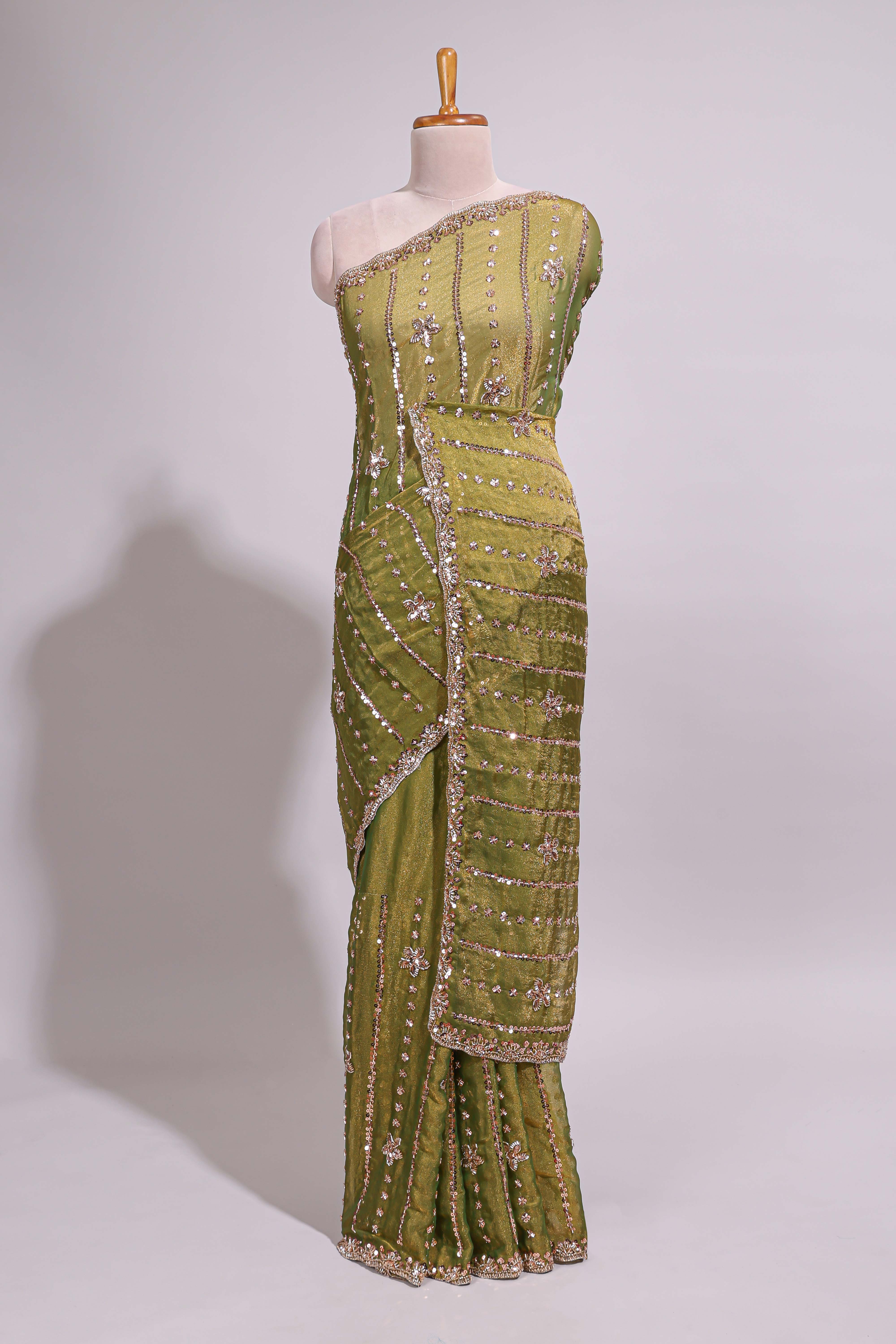 Olive green saree with silver sequin vertical lines floral motifs embellished border and matching pallu design along with matching blouse