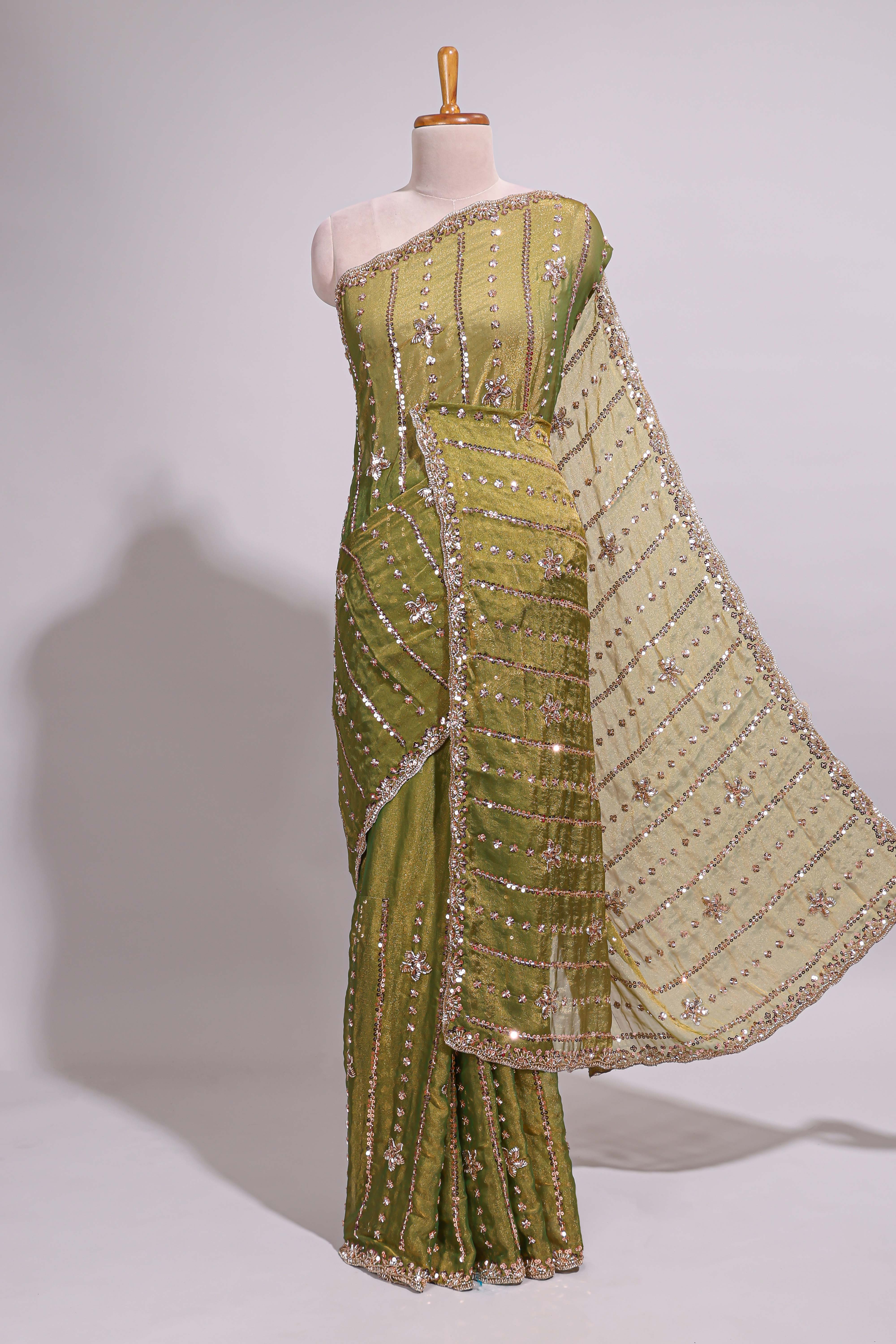 Olive green saree with silver sequin vertical lines floral motifs embellished border and matching pallu design along with matching blouse