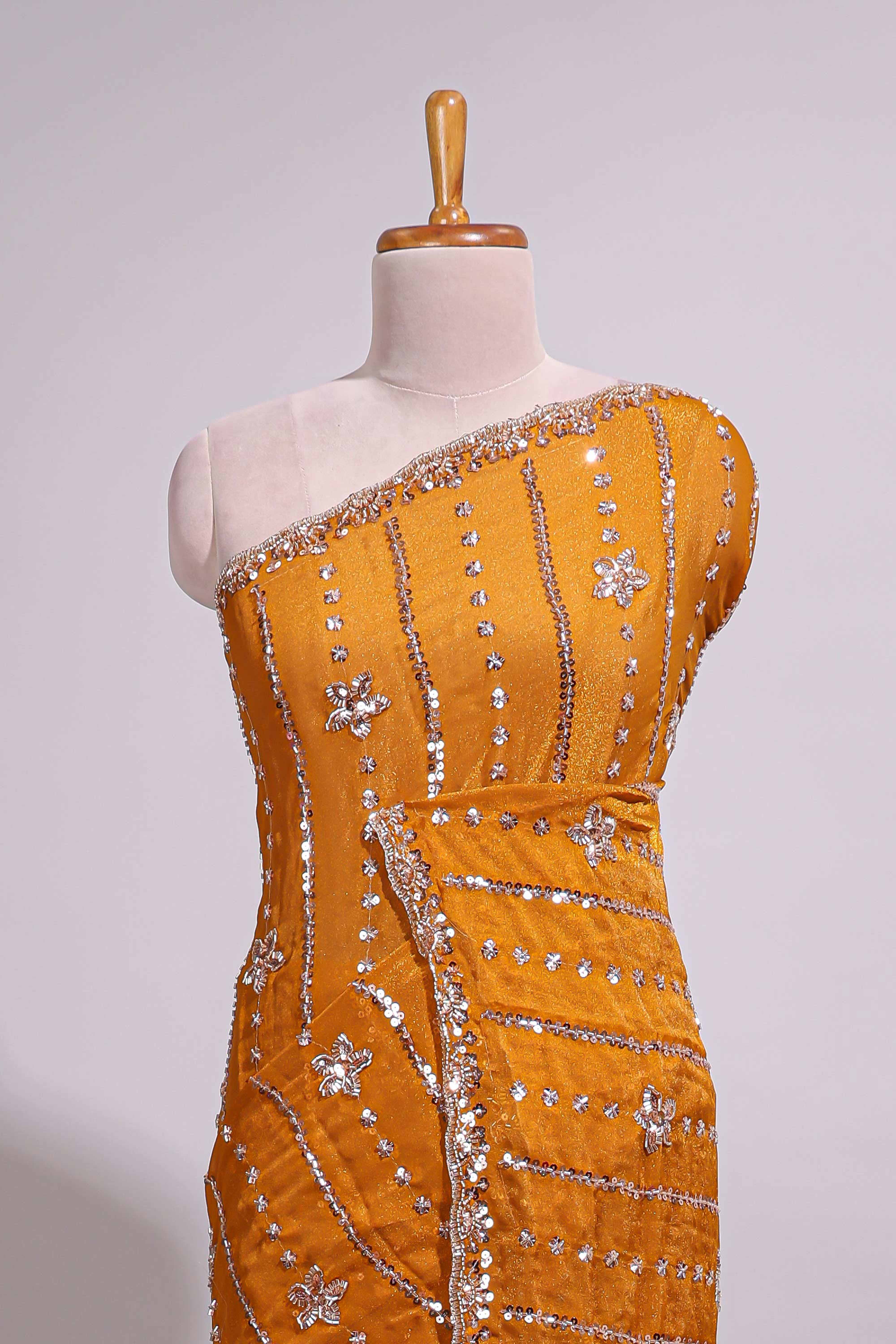 Mustard yellow saree with silver sequin vertical lines floral motifs embellished border and matching pallu design along with matching blouse