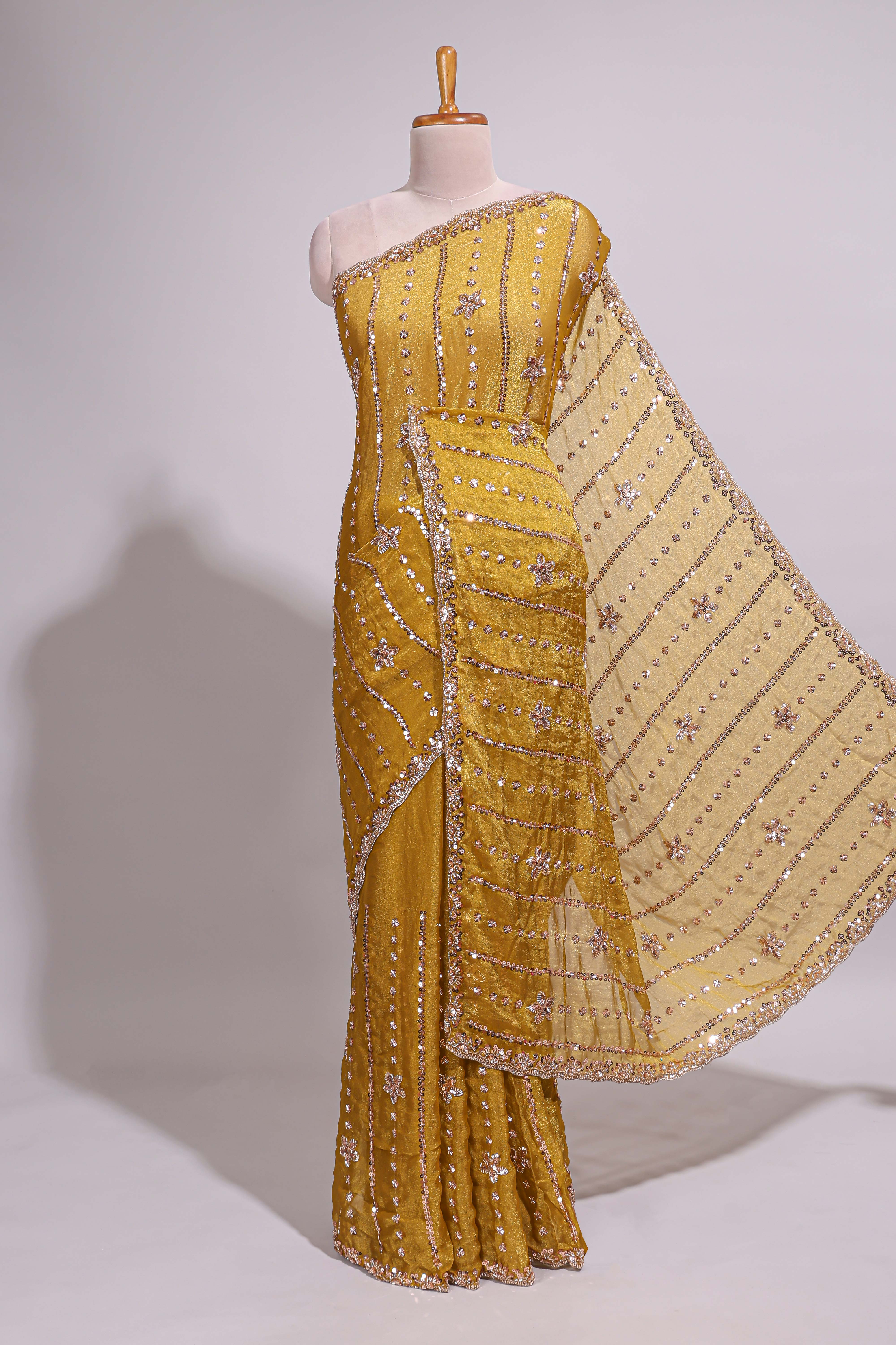 Turmeric yellow saree with silver sequin vertical lines floral motifs embellished border and matching pallu design along with matching blouse