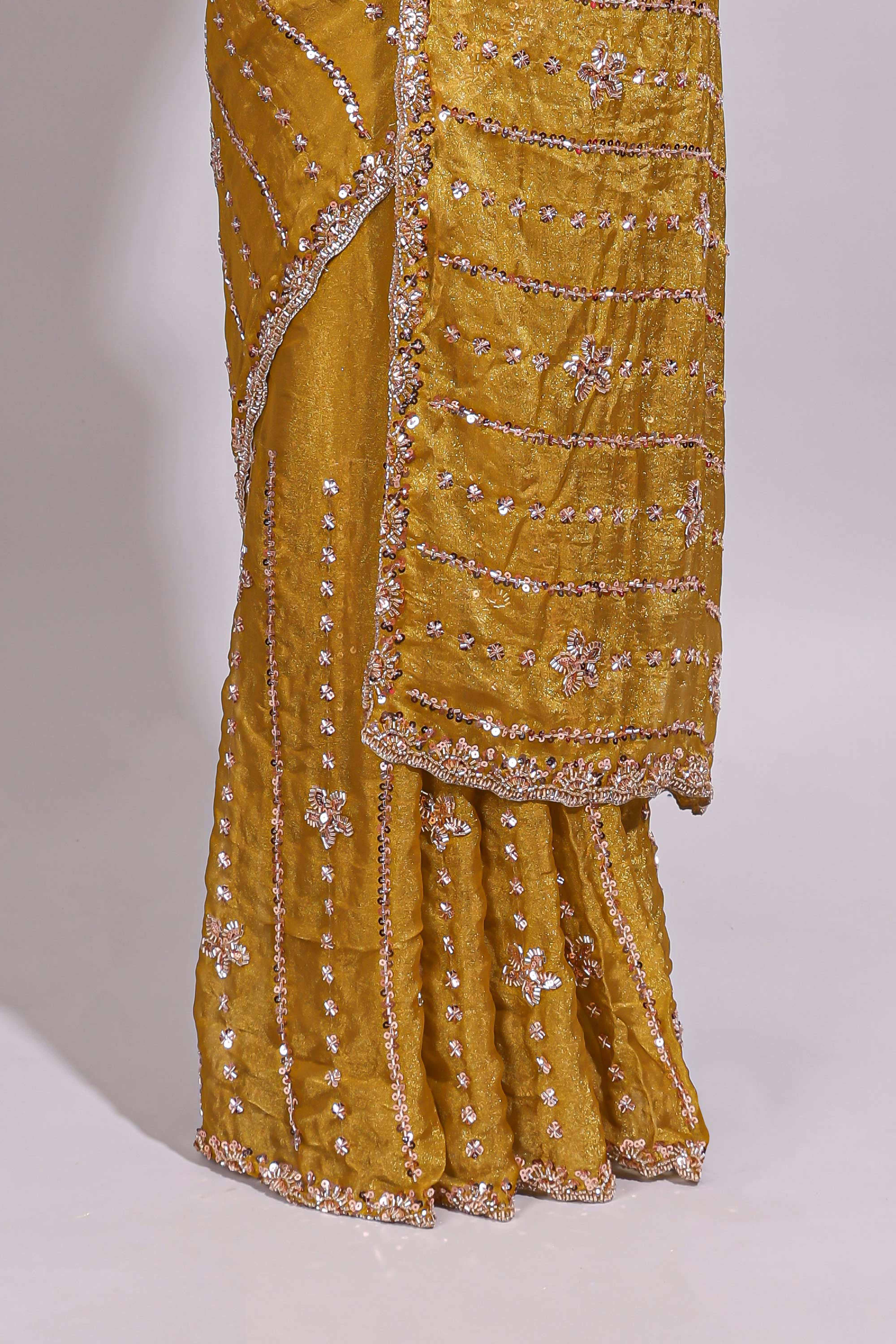 Turmeric yellow saree with silver sequin vertical lines floral motifs embellished border and matching pallu design along with matching blouse