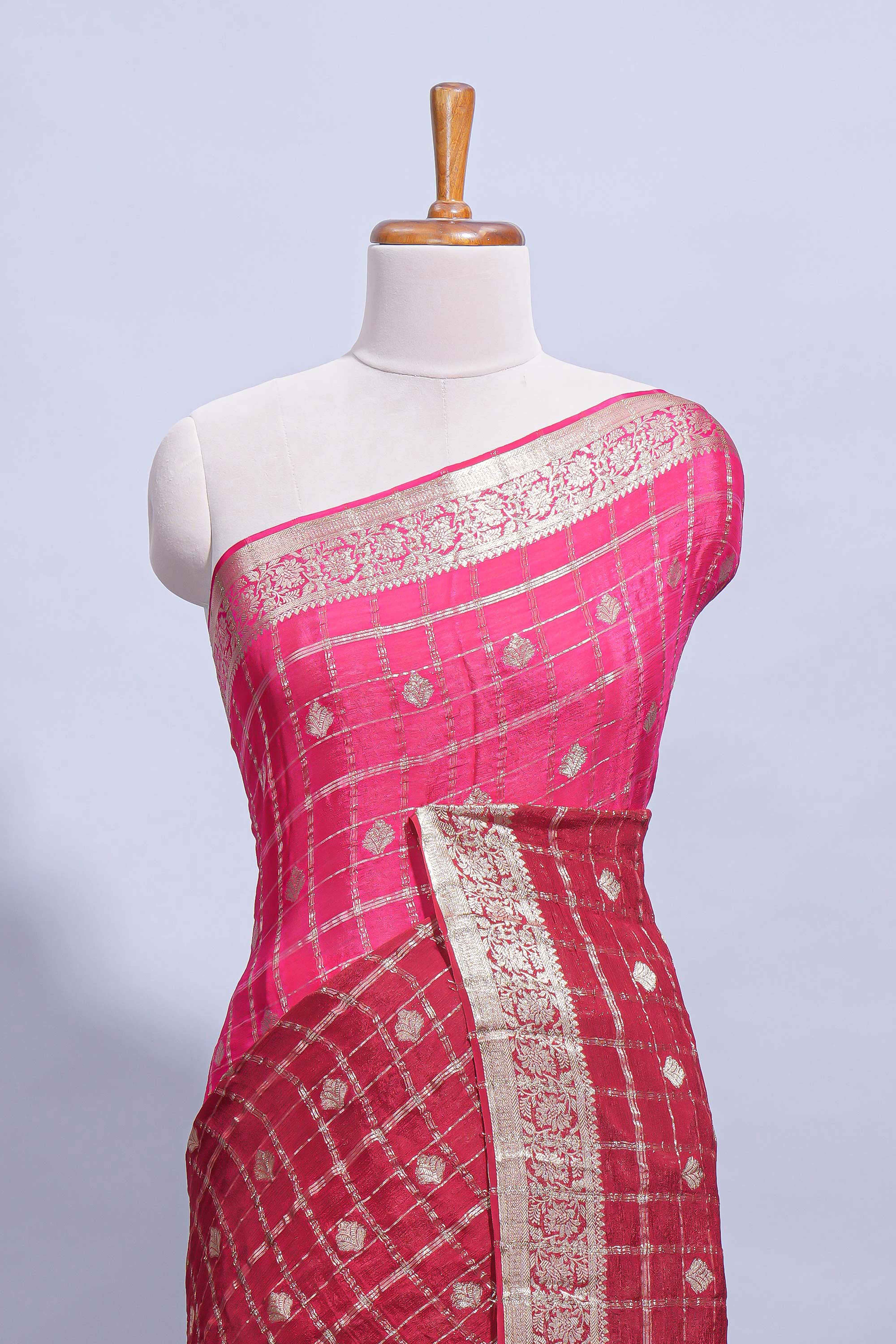 Rani pink double shaded zari checks georgette saree with small zari border and self pallu along with matching zari buttas blouse piece