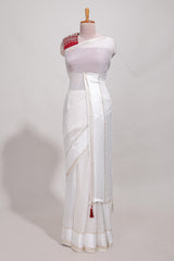 White zari checks georgette saree with small zari border and contrast aari work blouse