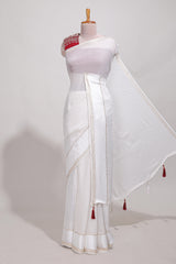 White zari checks georgette saree with small zari border and contrast aari work blouse