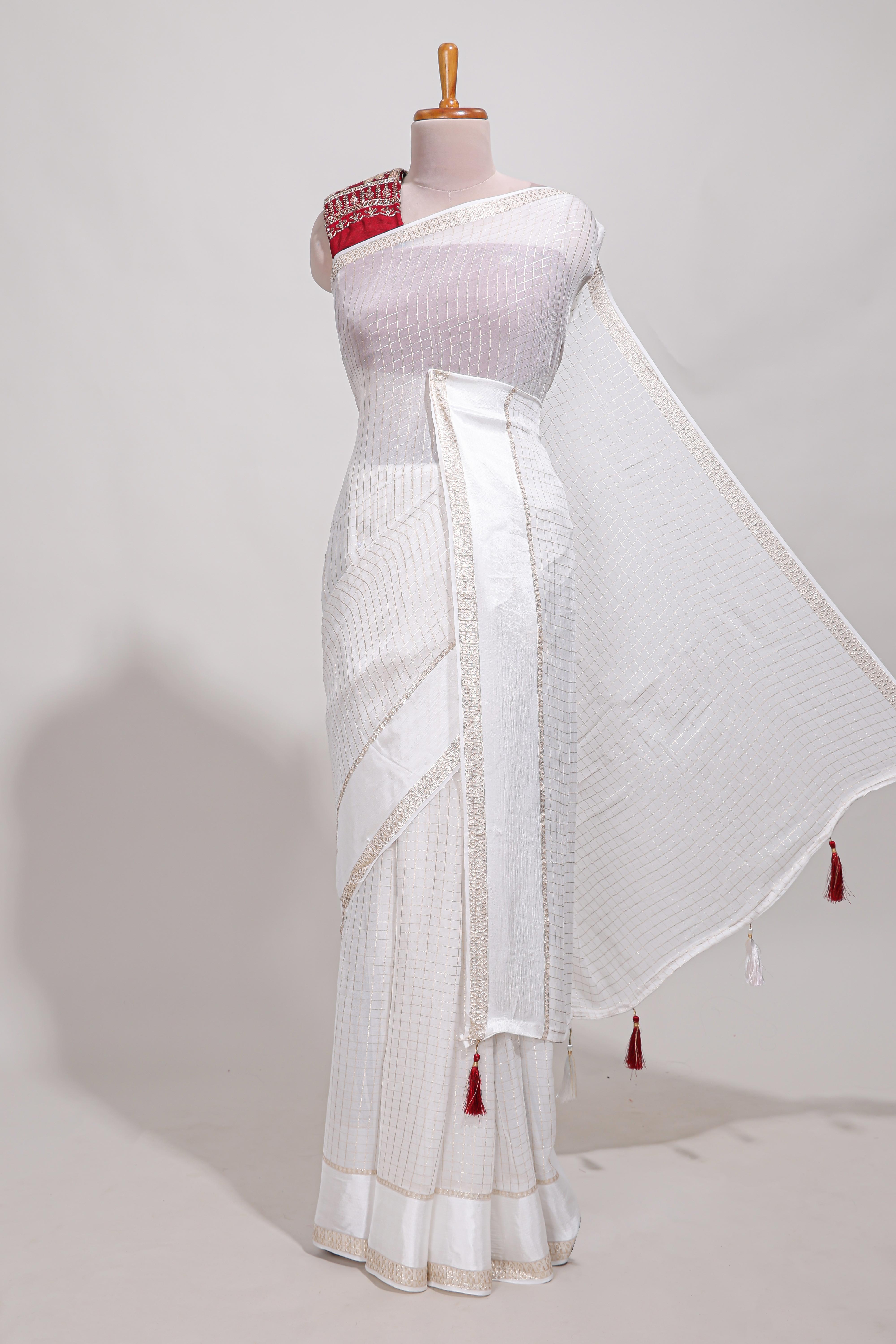 White zari checks georgette saree with small zari border and contrast aari work blouse