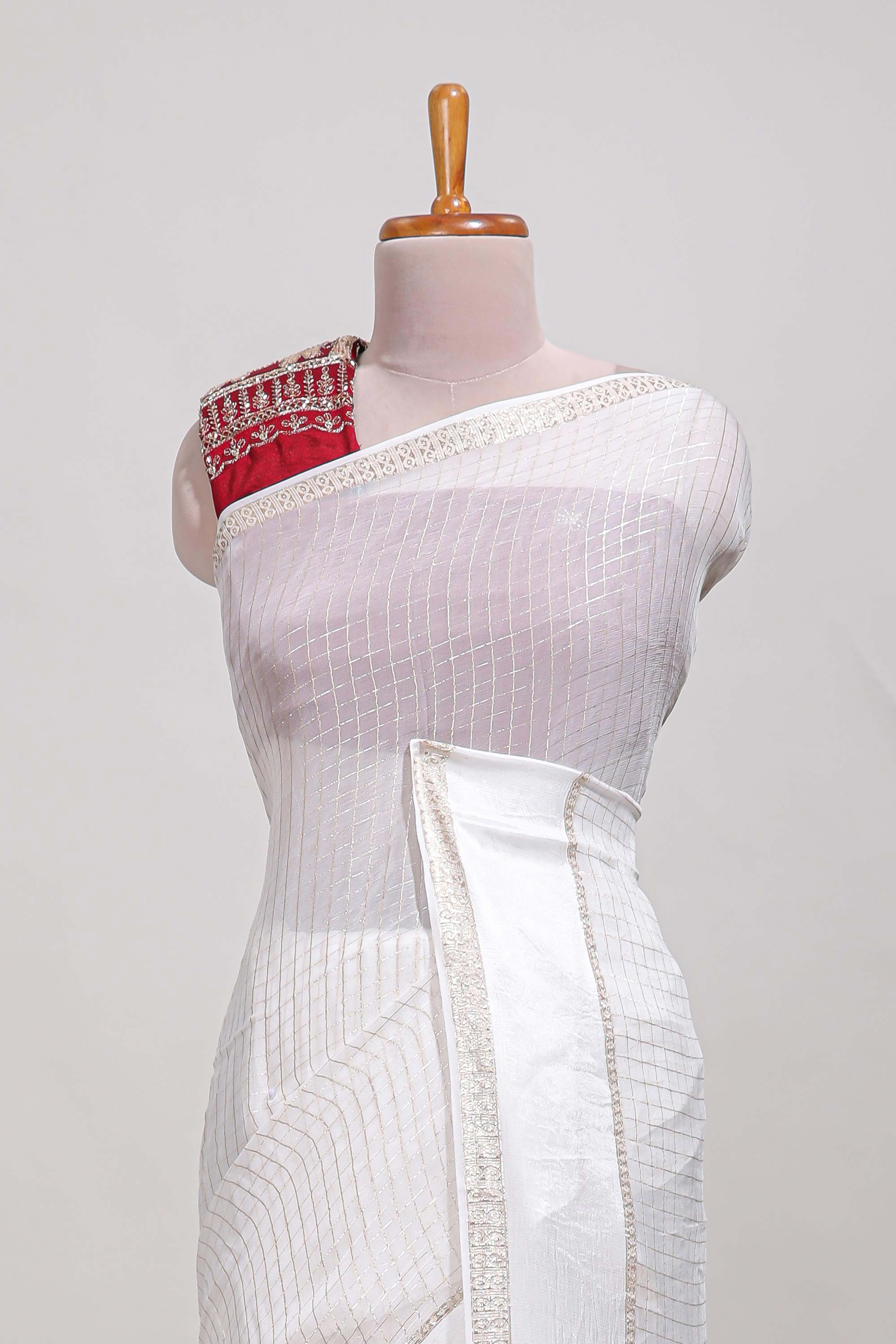 White zari checks georgette saree with small zari border and contrast aari work blouse