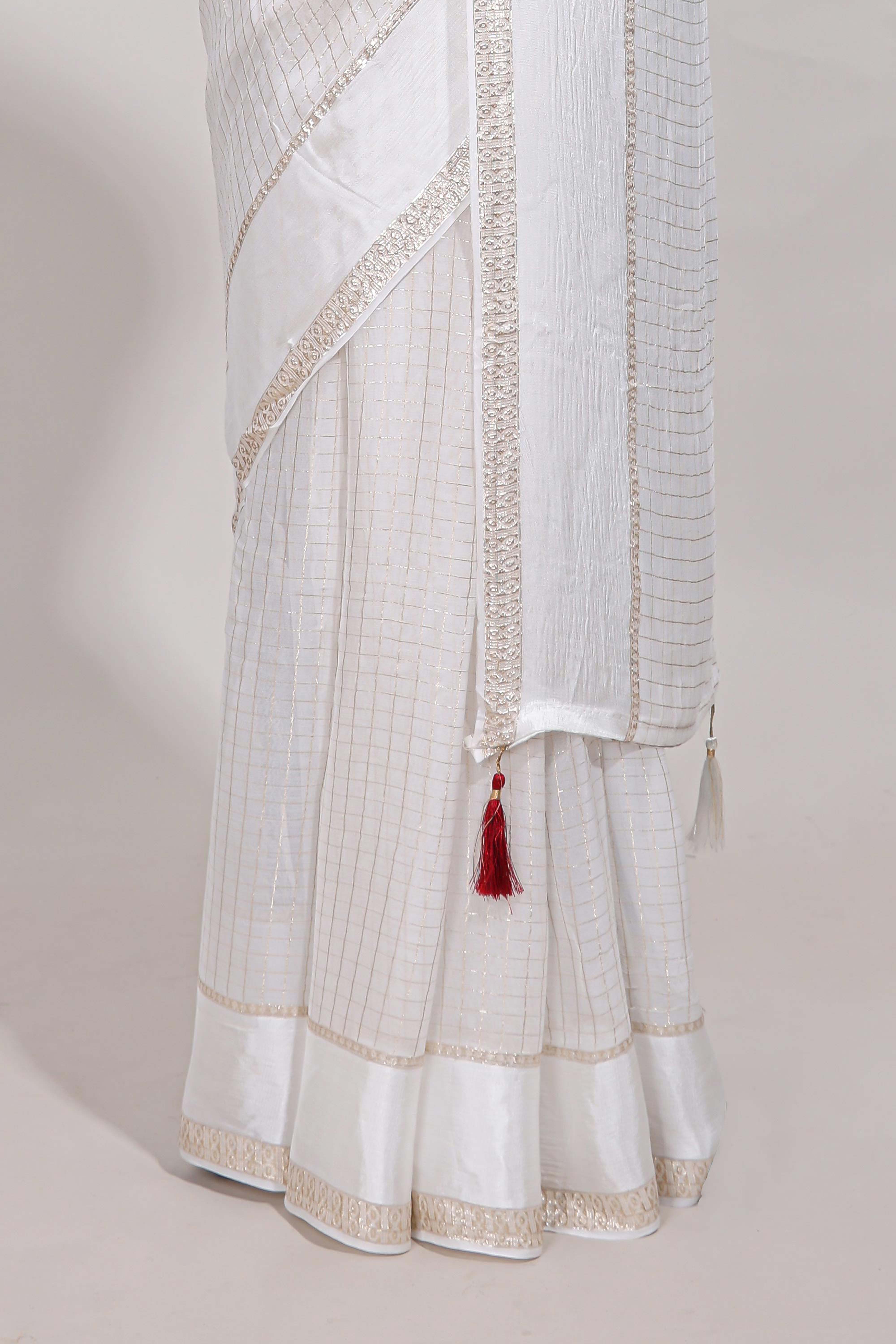 White zari checks georgette saree with small zari border and contrast aari work blouse