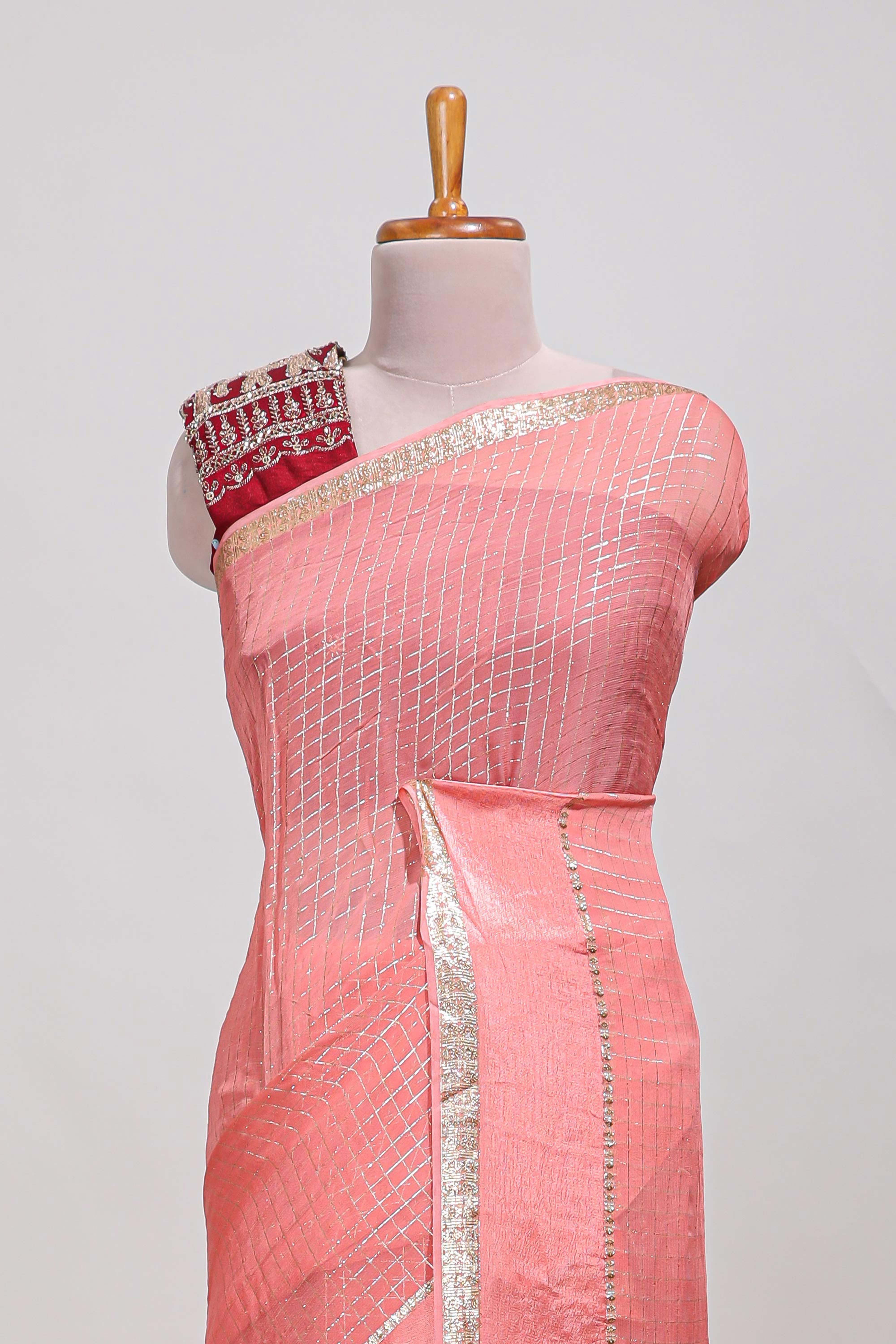 Peach zari checks georgette saree with small zari border and contrast aari work blouse