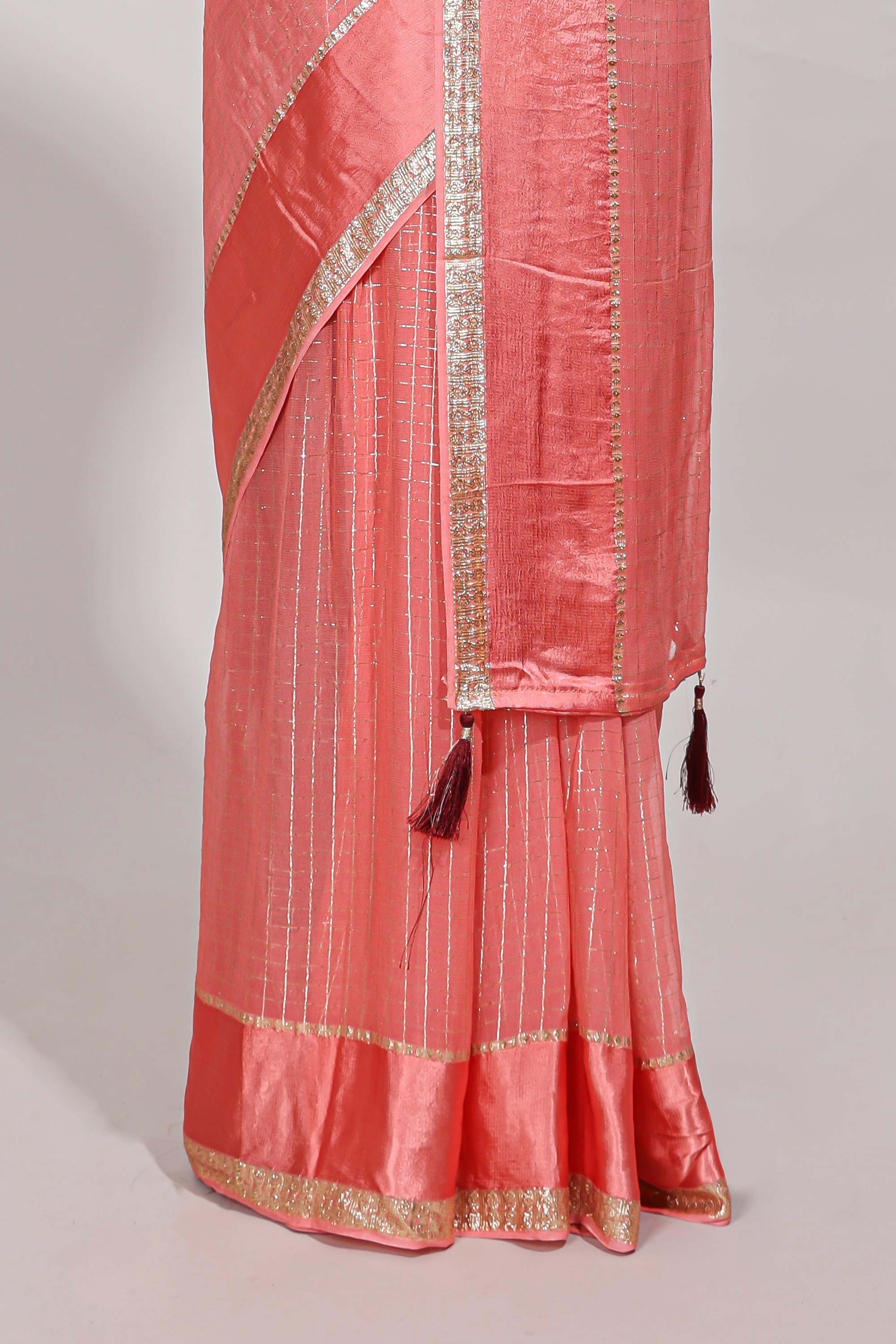 Peach zari checks georgette saree with small zari border and contrast aari work blouse