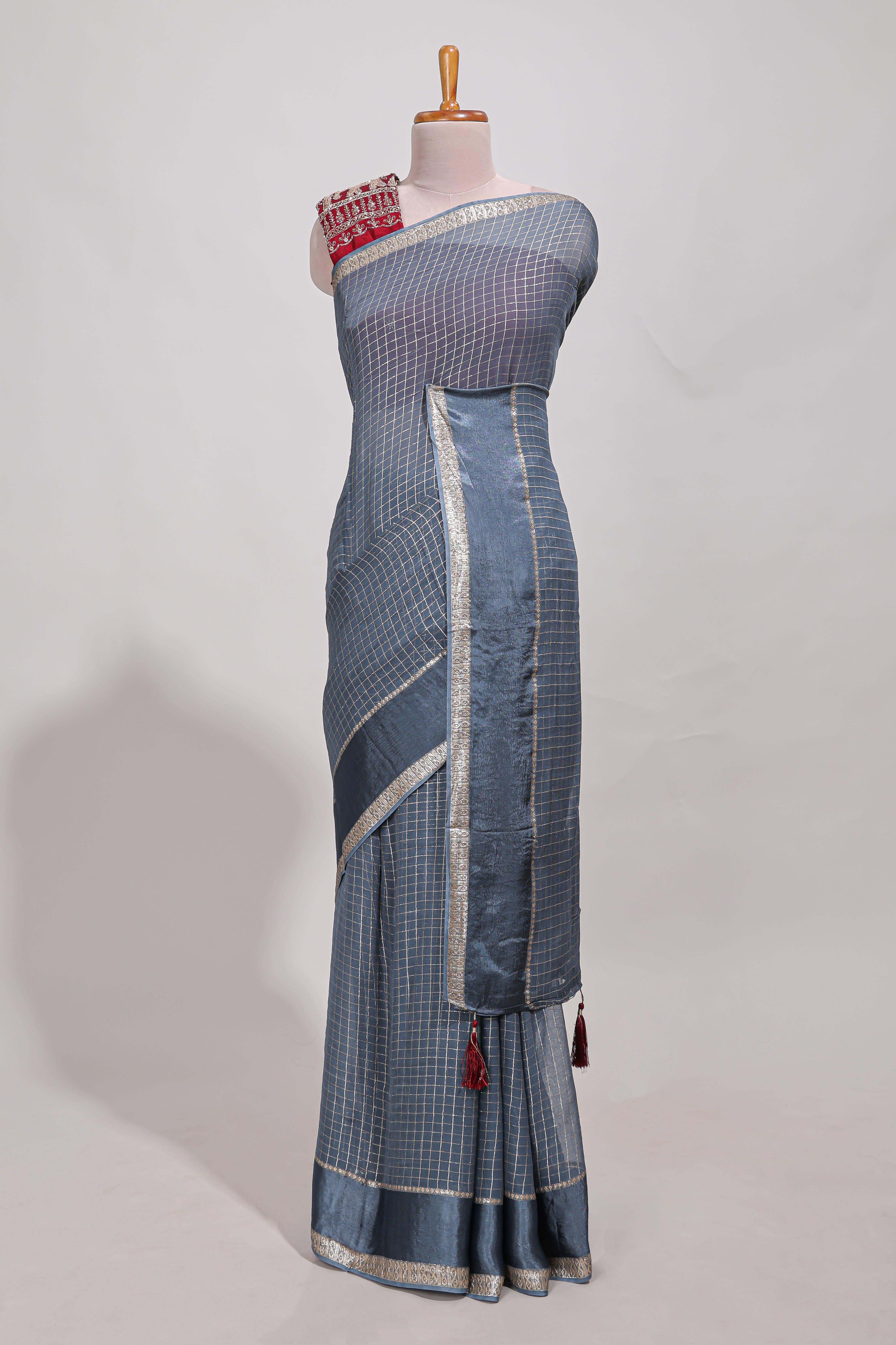 Gray zari checks georgette saree with small zari border and contrast aari work blouse