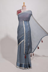 Gray zari checks georgette saree with small zari border and contrast aari work blouse