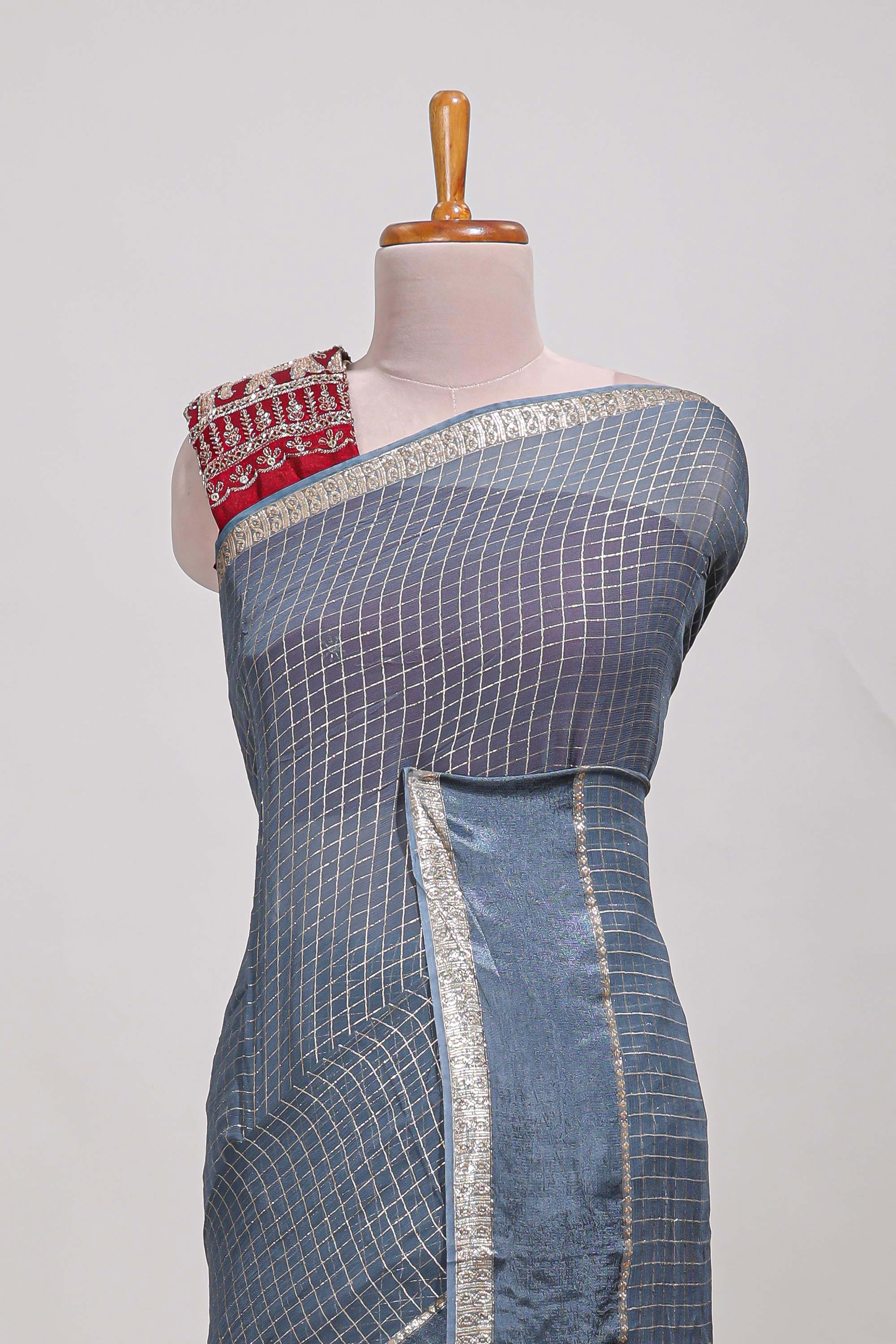 Gray zari checks georgette saree with small zari border and contrast aari work blouse