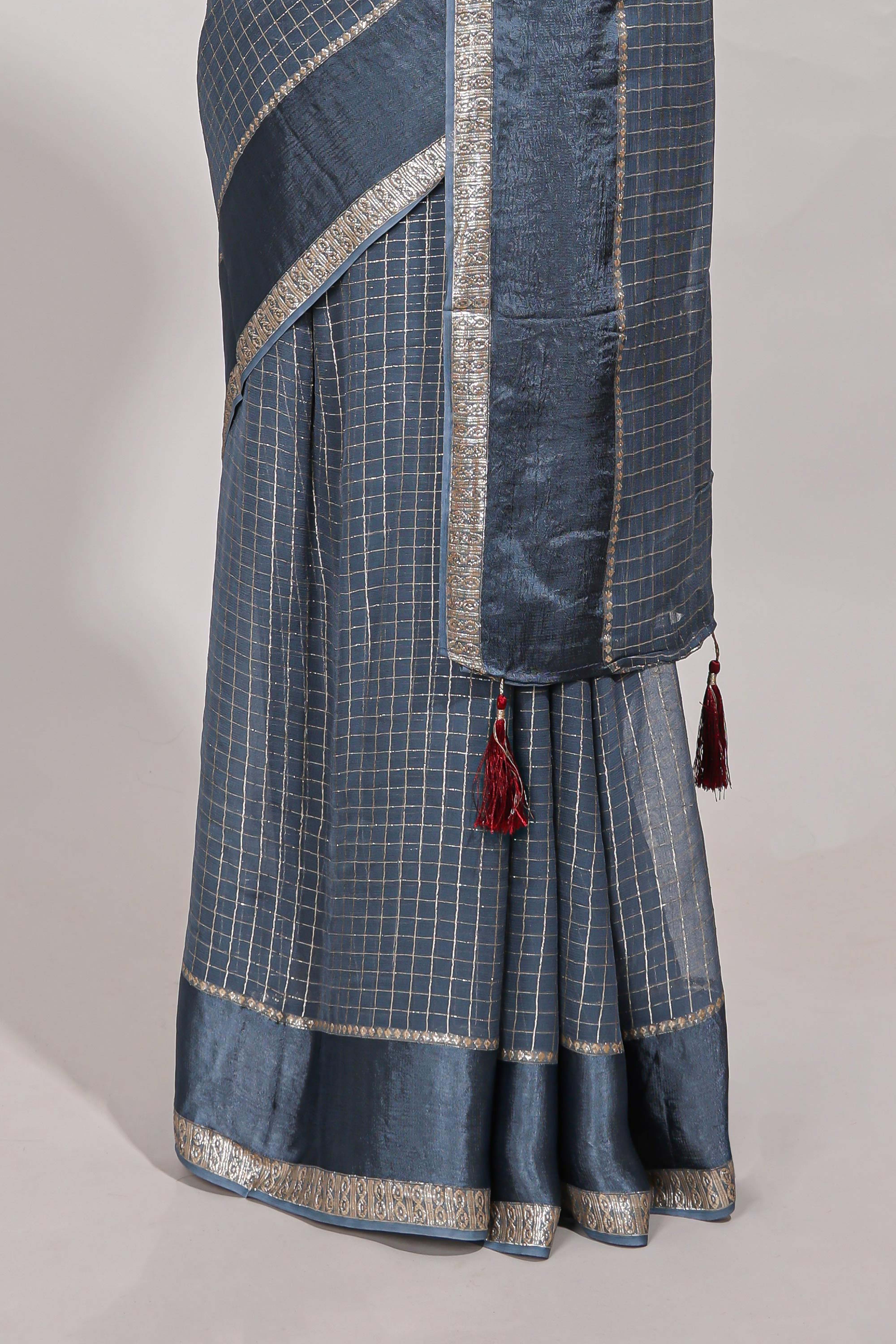 Gray zari checks georgette saree with small zari border and contrast aari work blouse