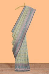 Green geometric motifs design ikkat cotton saree with contrast zari design border and zari floral motifs blouse