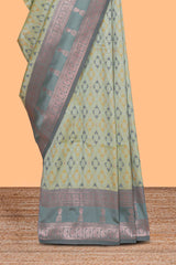 Green geometric motifs design ikkat cotton saree with contrast zari design border and zari floral motifs blouse