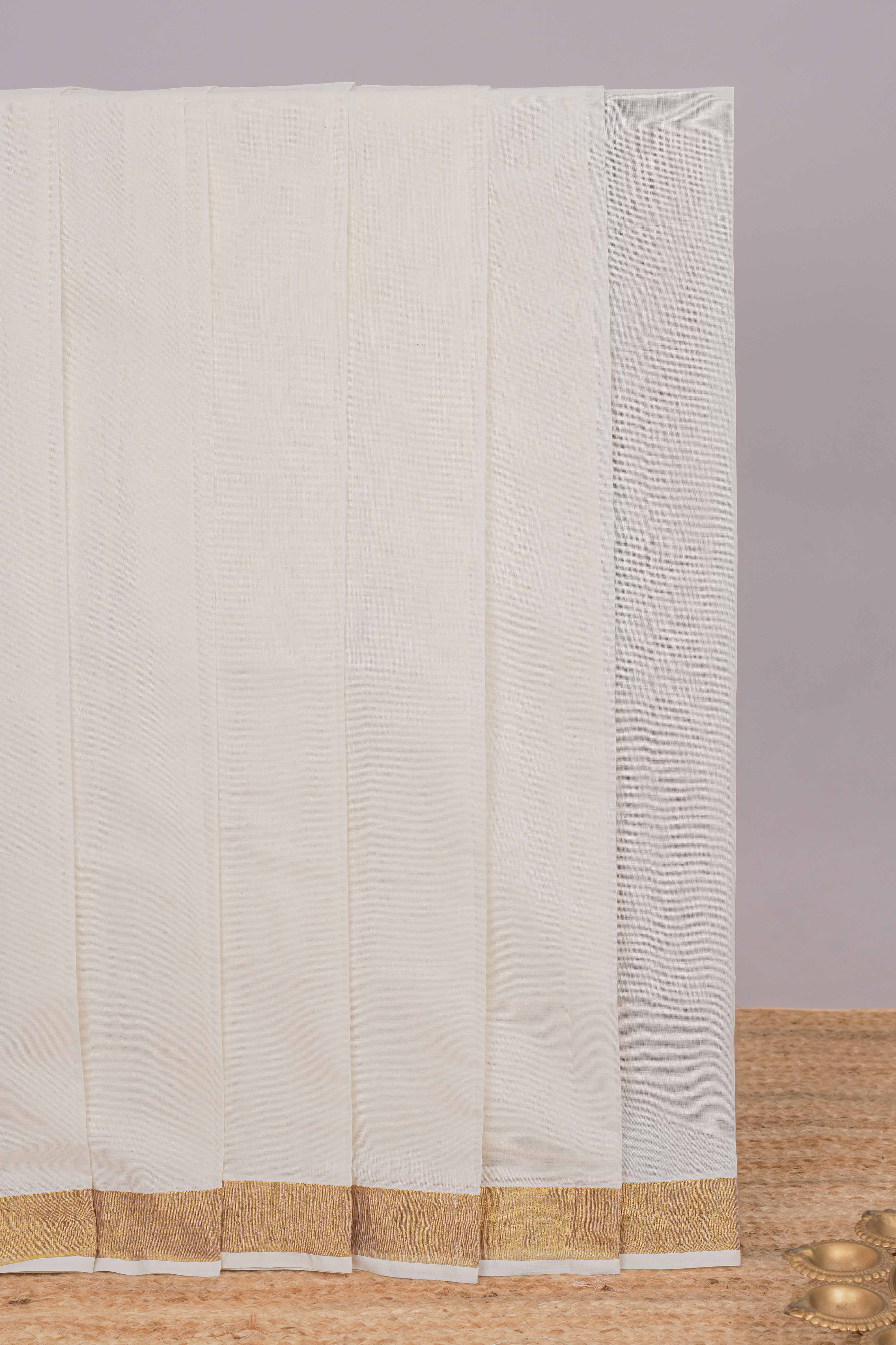 Cream plain design kerala cotton saree with self zari border and peacock design pallu