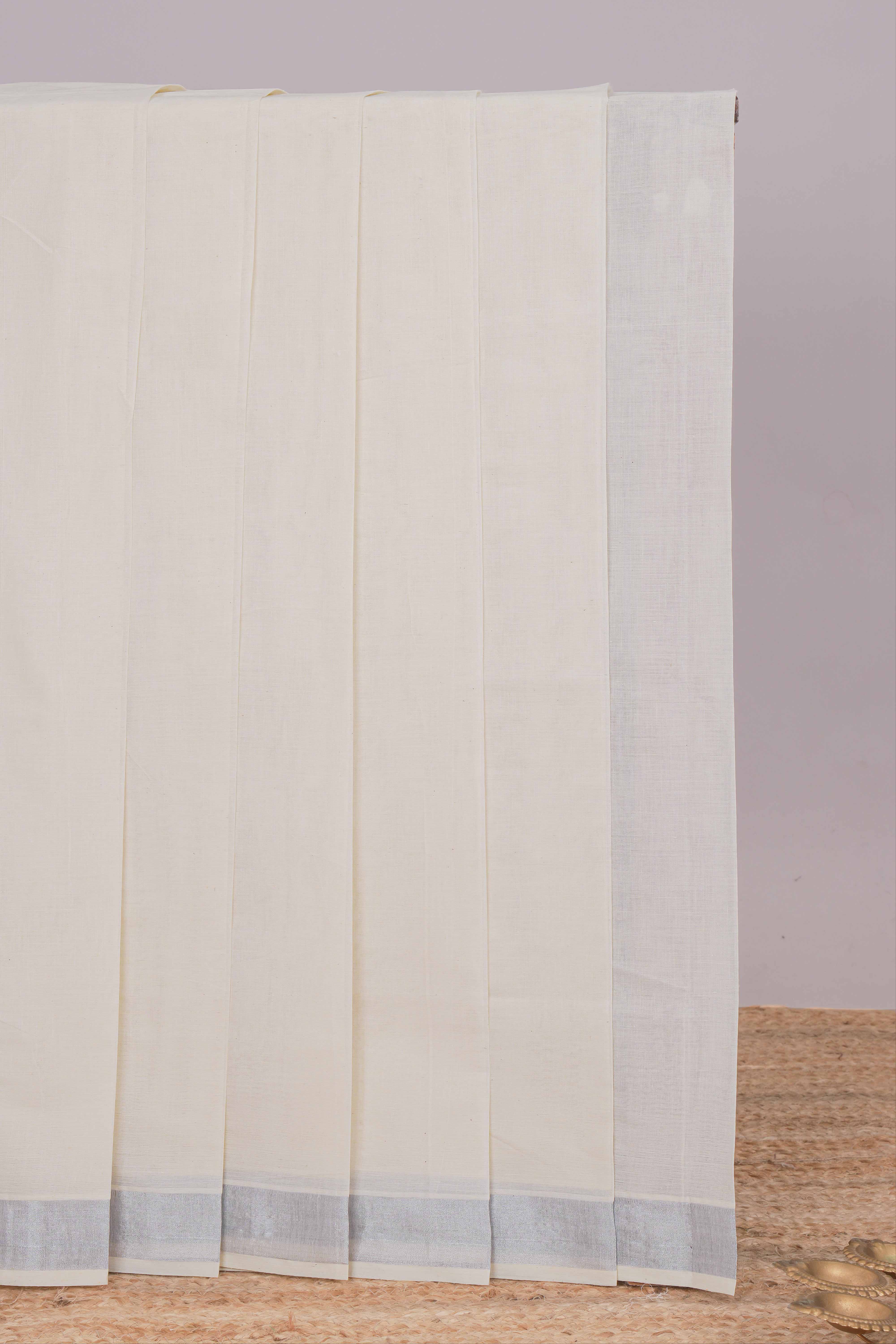 Cream plain design kerala cotton saree with self silver zari border and matching blouse