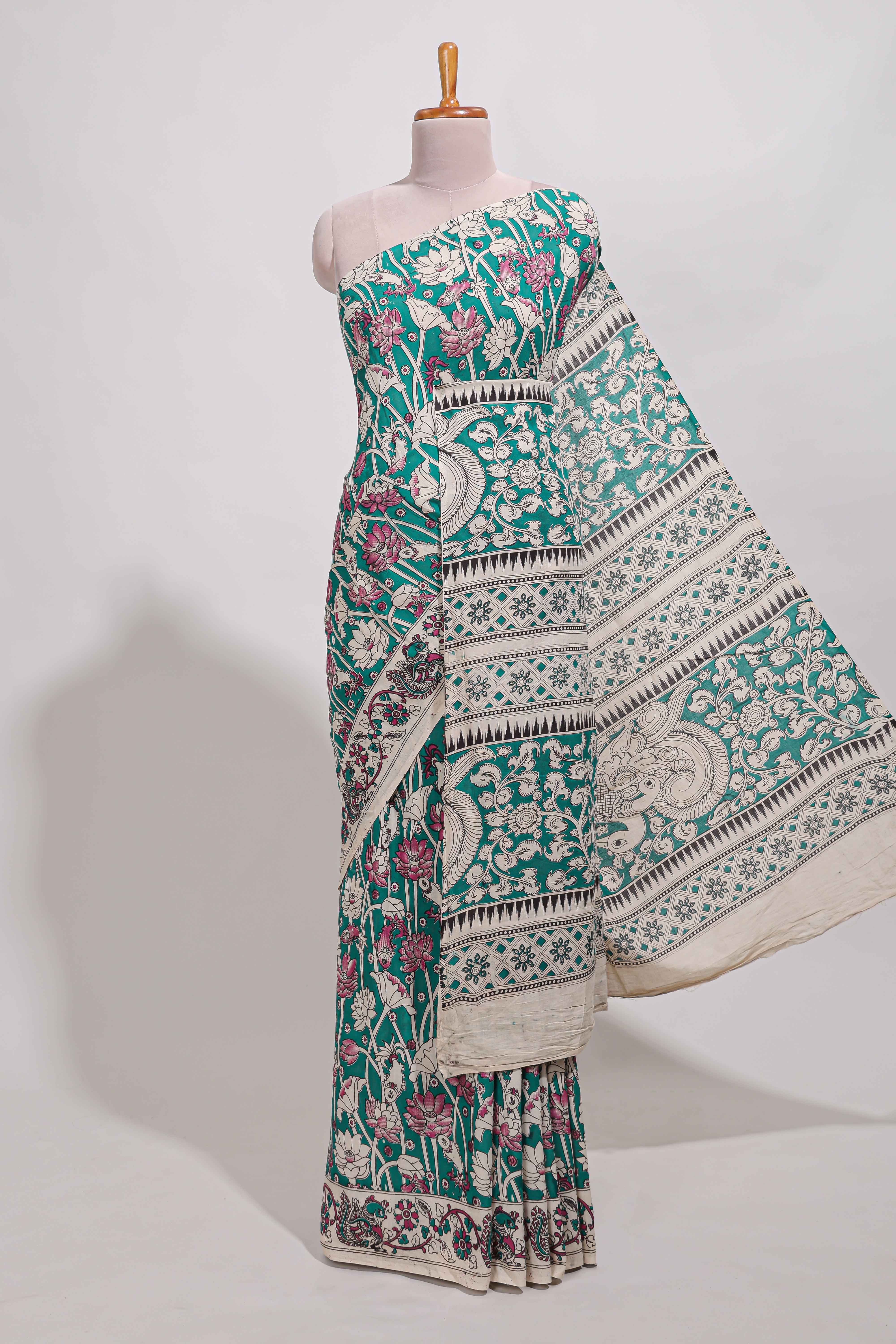 Green kalamkari printed cotton saree with traditional floral motifs and contrast pallu