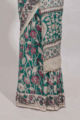 Green kalamkari printed cotton saree with traditional floral motifs and contrast pallu