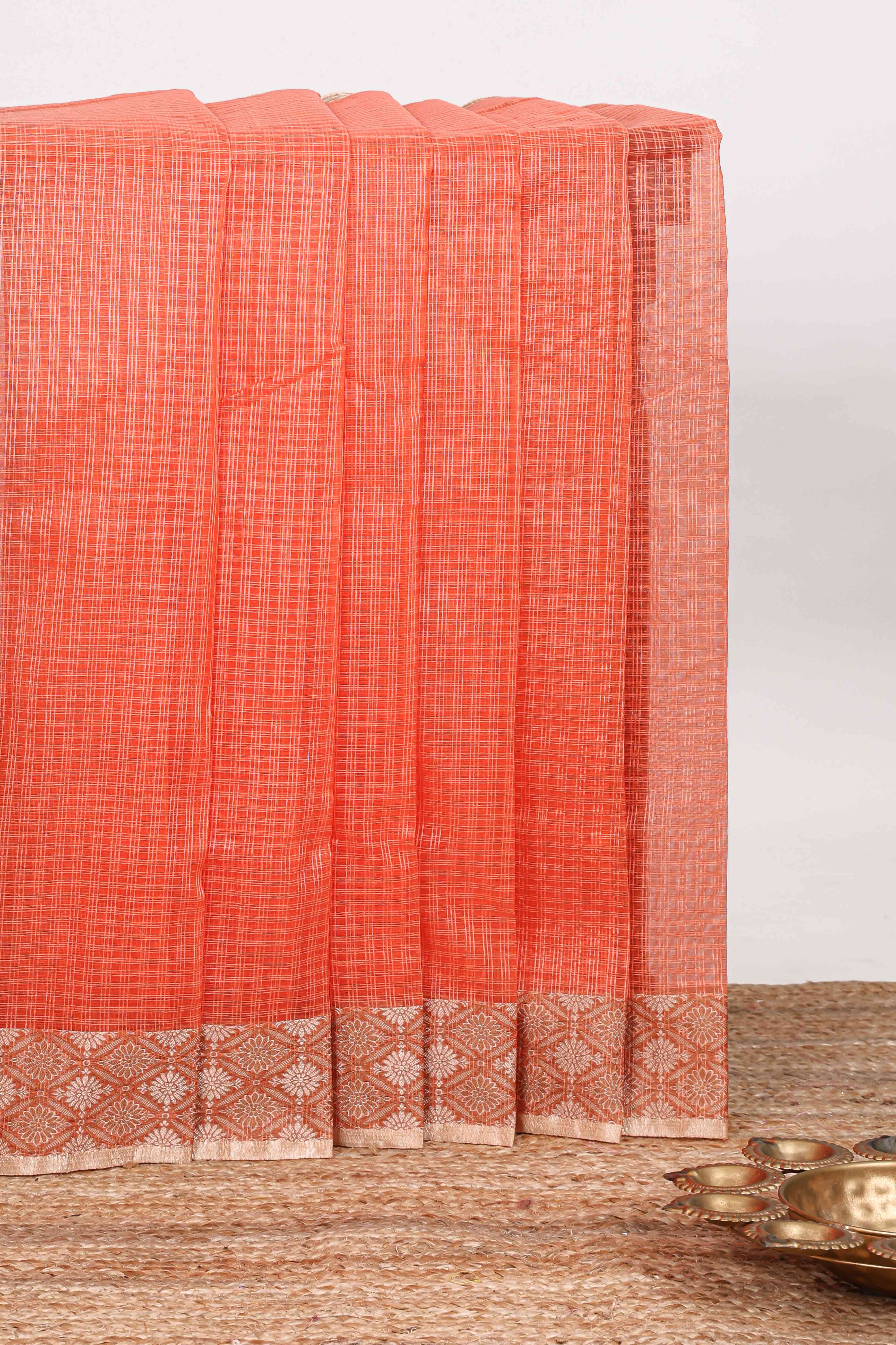 Orange checked kota cotton saree with contrast border and floral design blouse