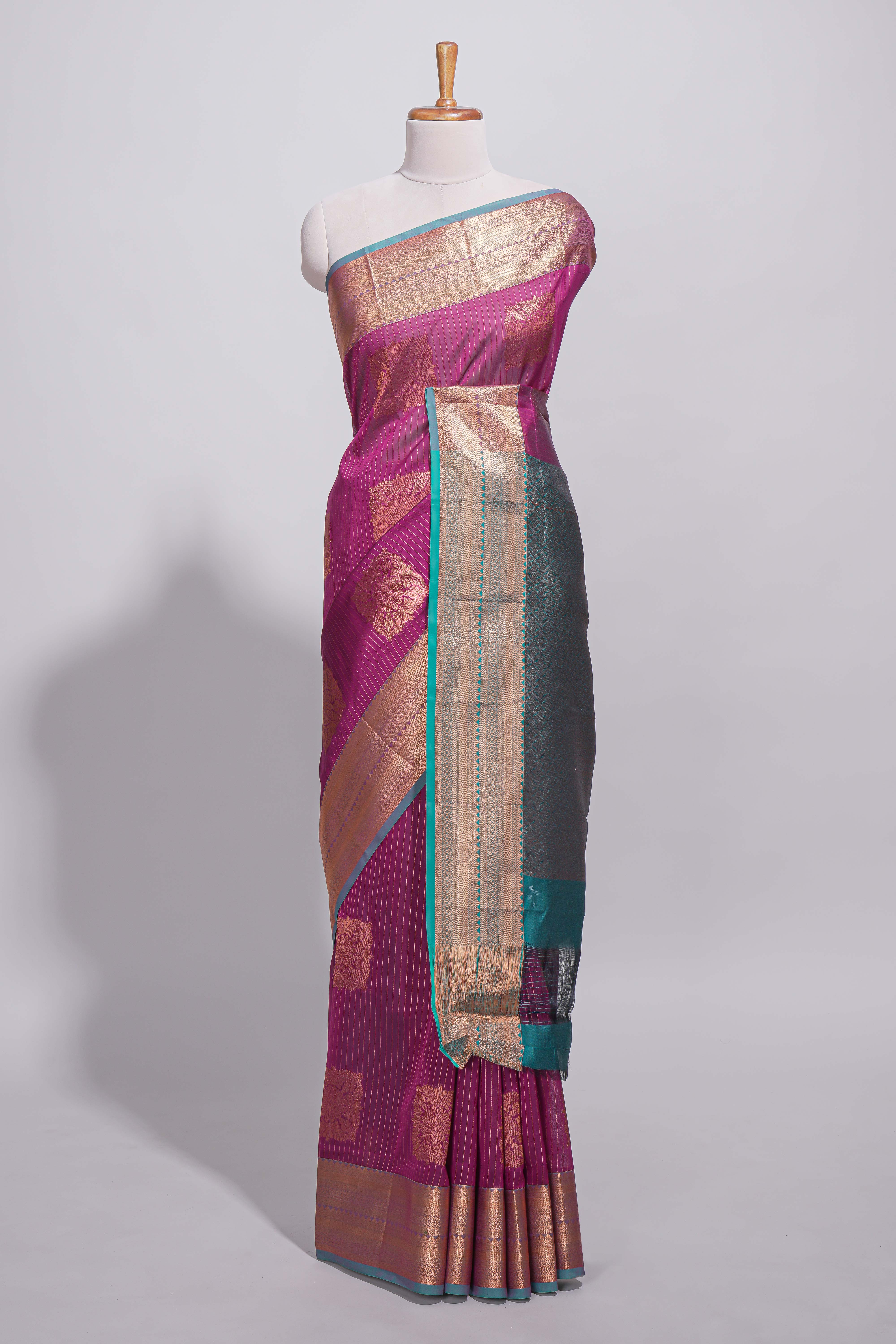 Rich magenta tussar saree with gold zari floral buttas teal zari border and woven zari pallu with contrast blouse piece
