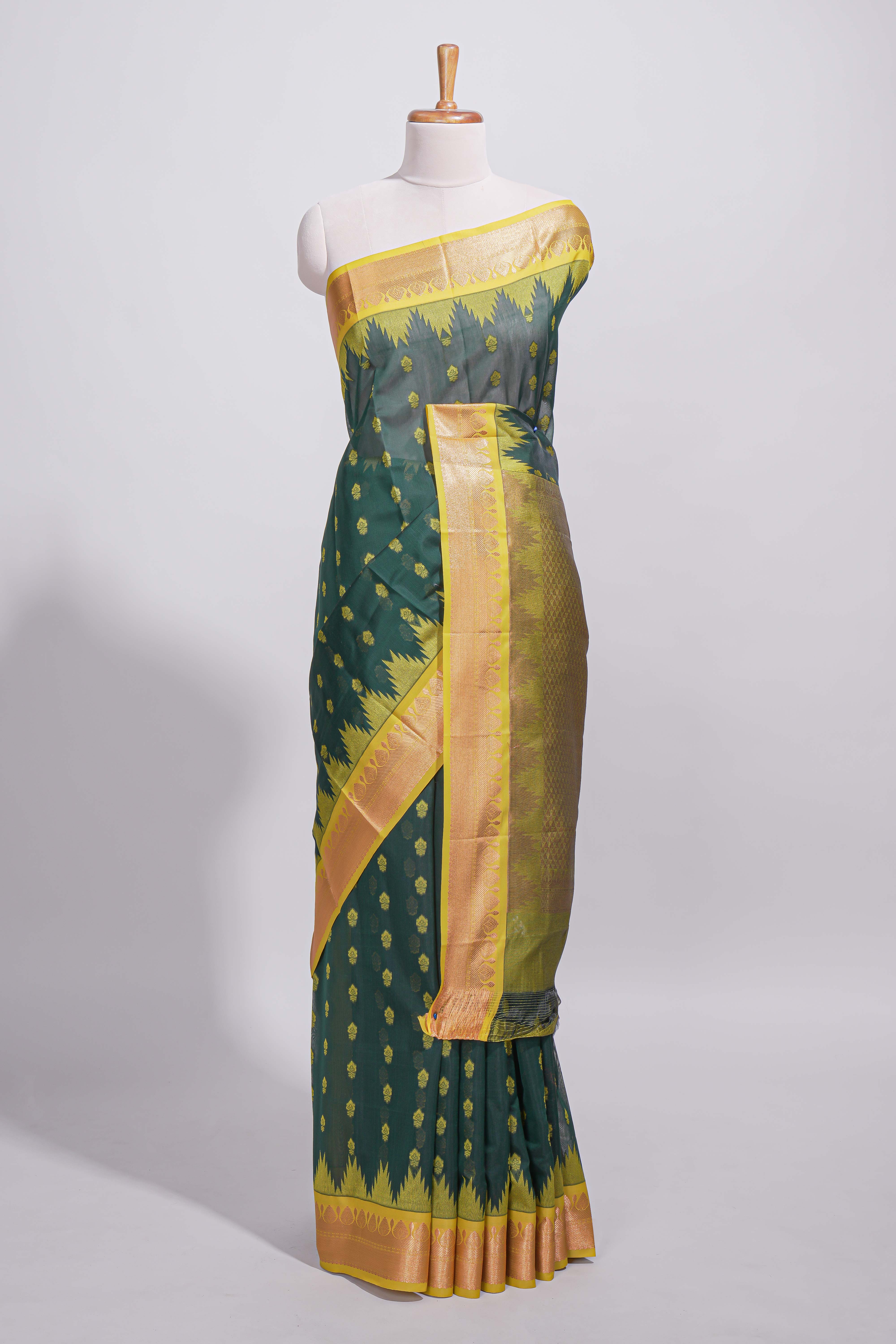 Dark teal green kotta cotton with gold zari buttas a zari border with temple design and zari woven pallu with matching blouse piece