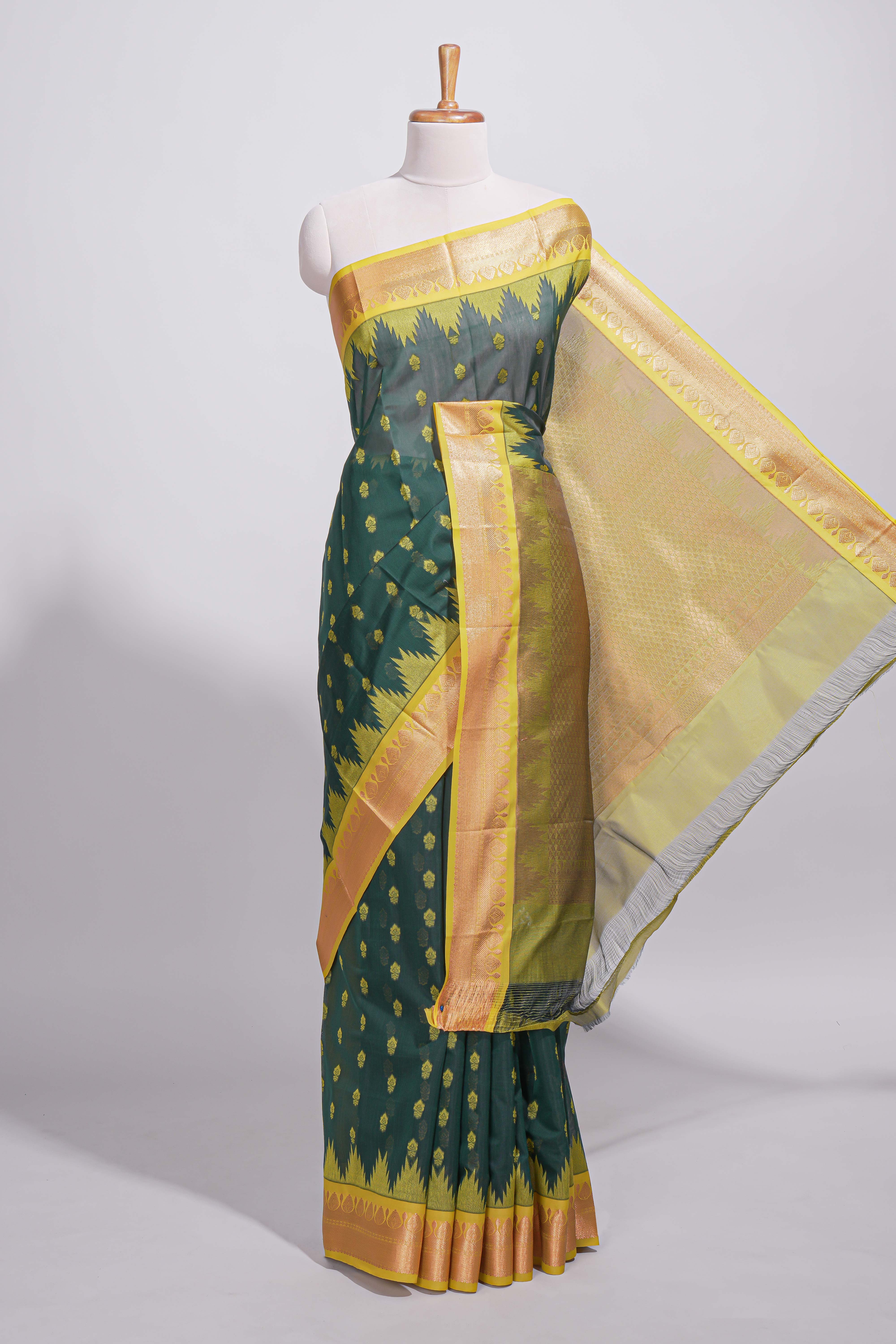 Dark teal green kotta cotton with gold zari buttas a zari border with temple design and zari woven pallu with matching blouse piece