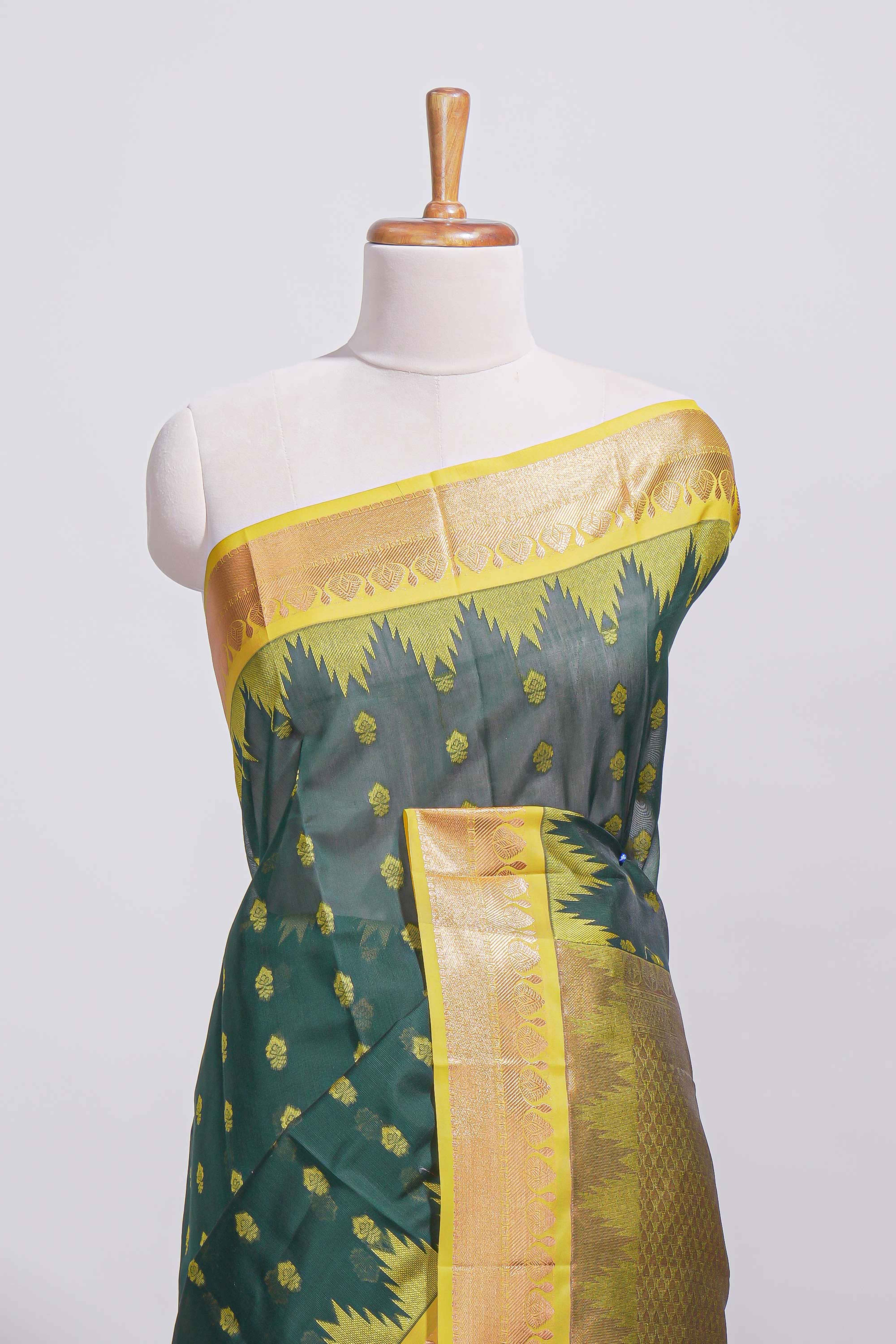 Dark teal green kotta cotton with gold zari buttas a zari border with temple design and zari woven pallu with matching blouse piece